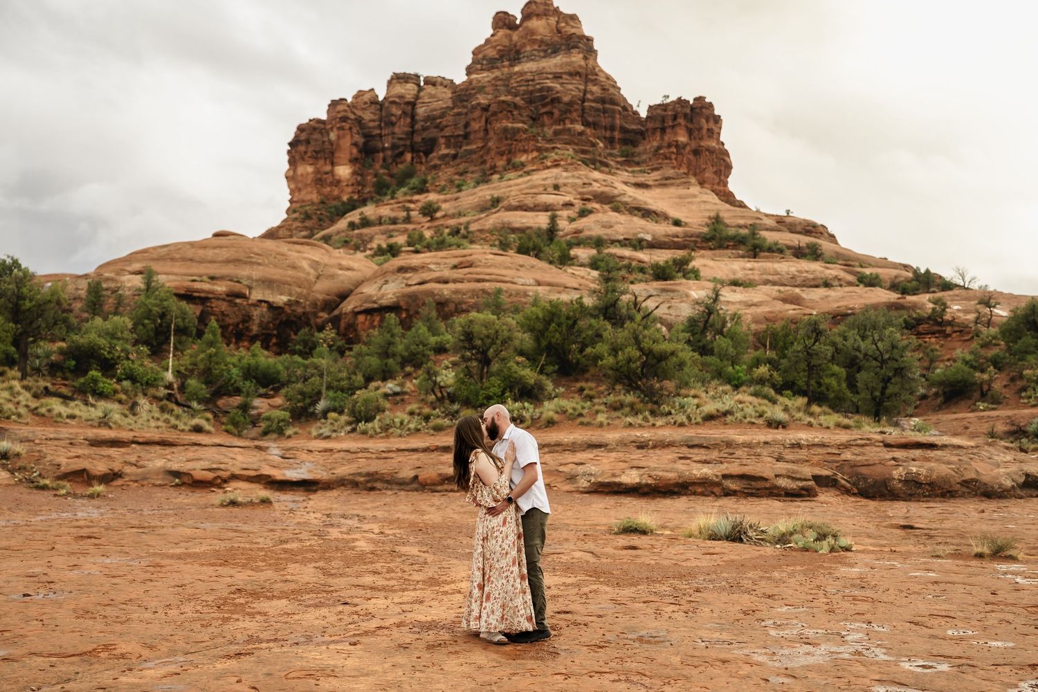 A romantic photo series with desert rock formations and moody clouds in the background.
