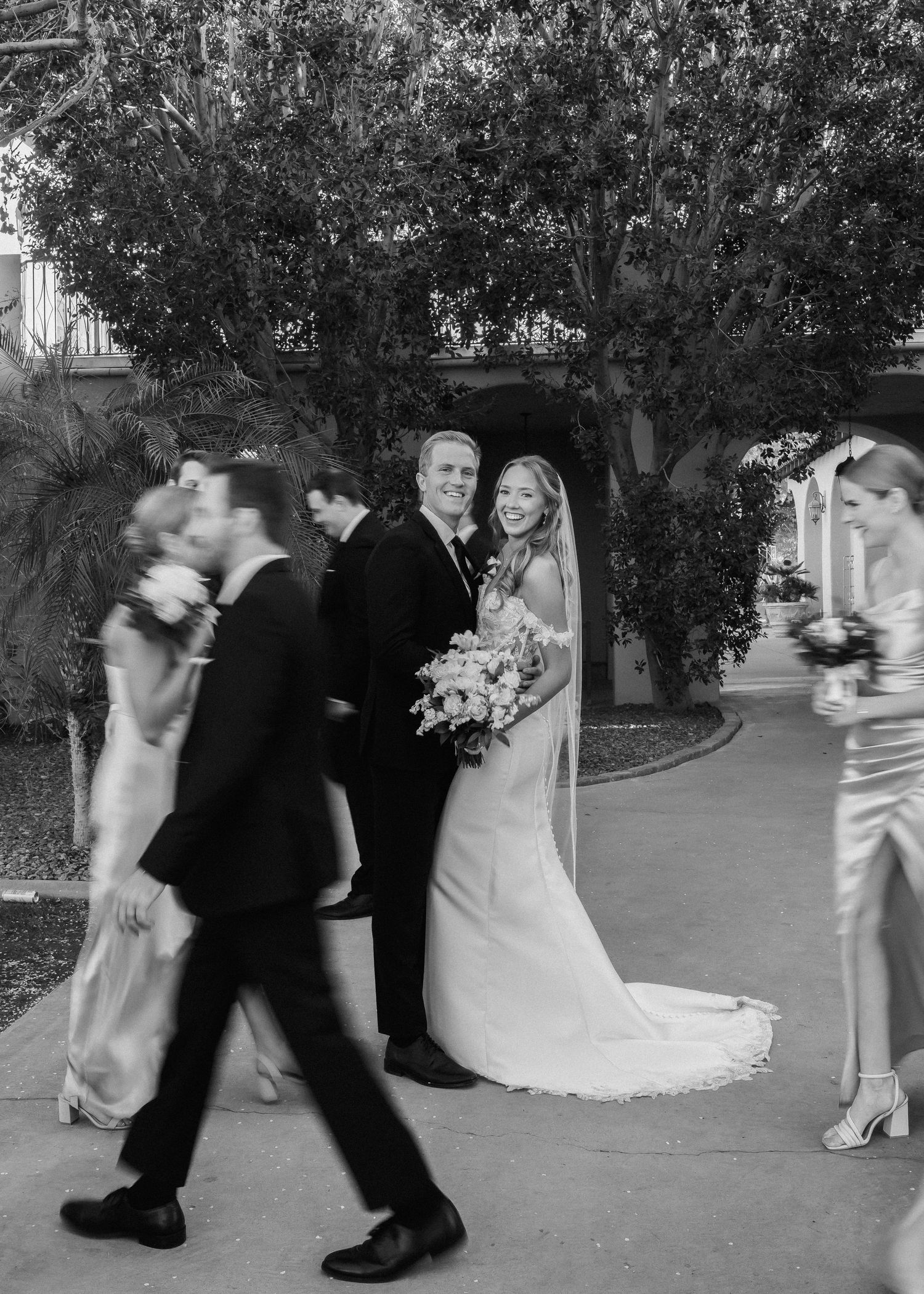 Black and white candid wedding dance photos showing movement and celebration.