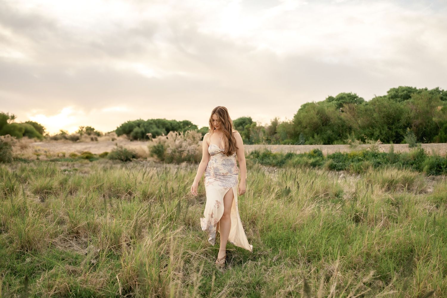 Rolling hills and greenery provide a scenic backdrop for an outdoor photoshoot.