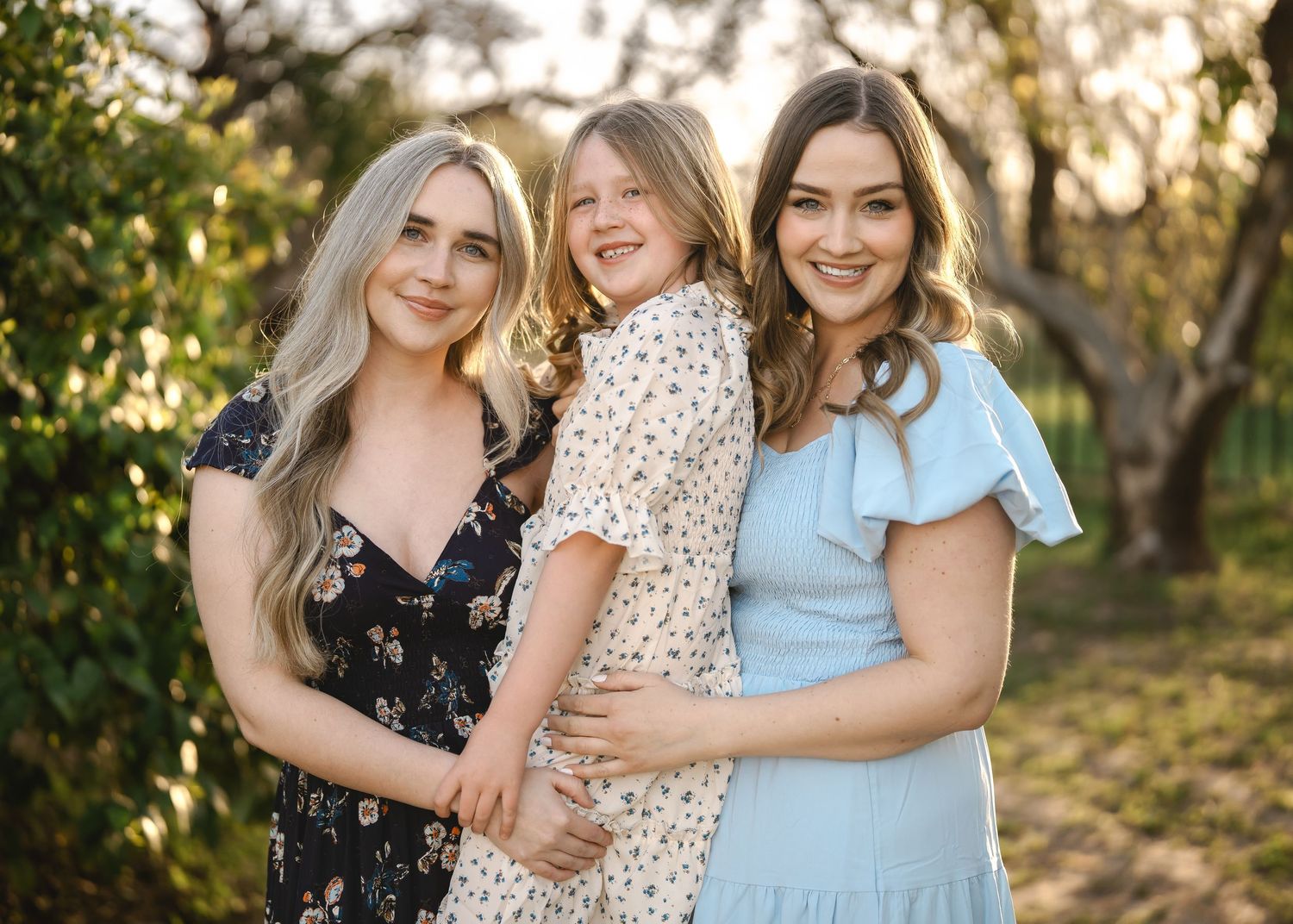 Candid family photo shoot moments showing embraces in matching spring outfits.