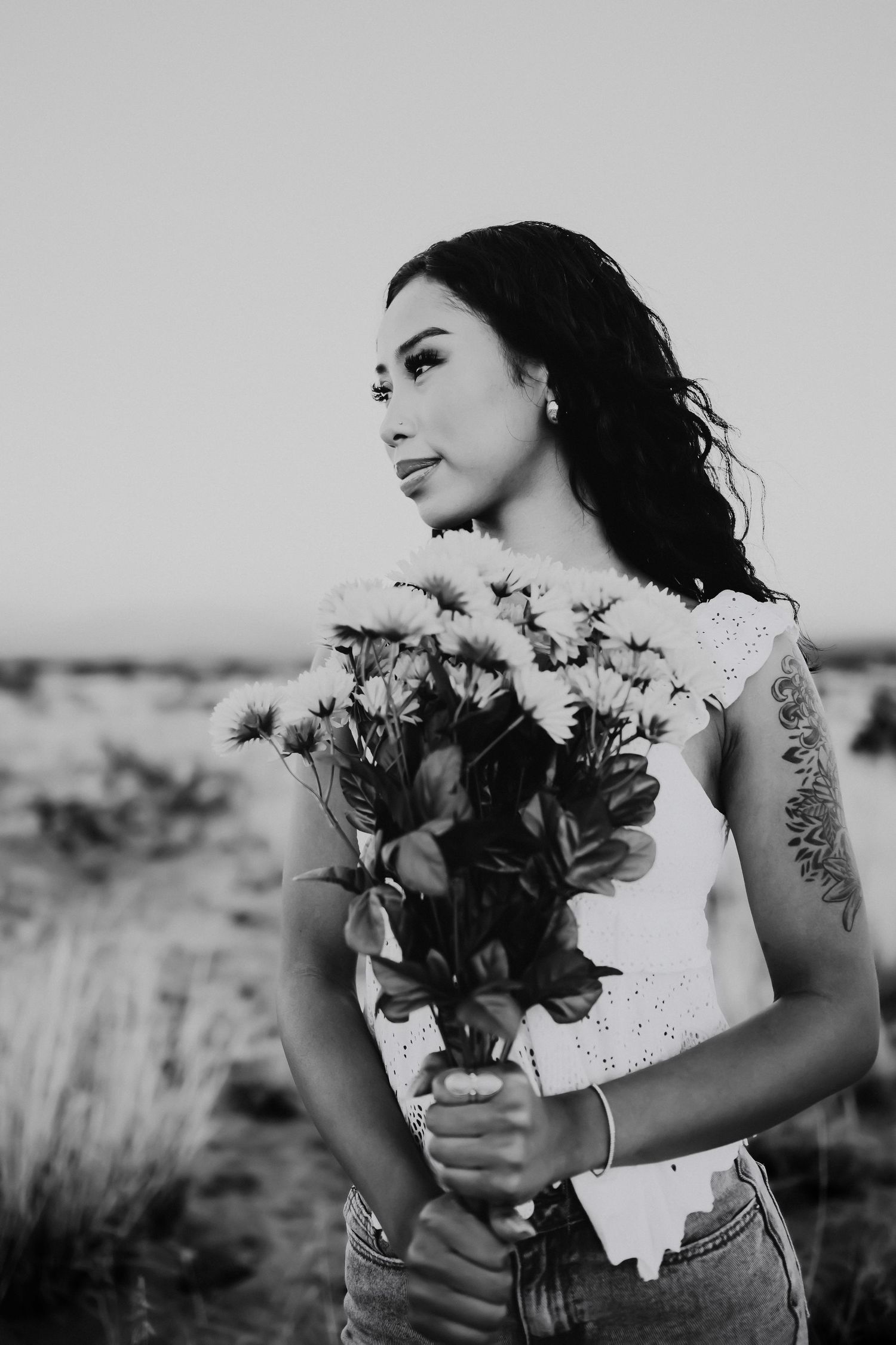 Senior portraits in Tucson Arizona desert holding flowers black and white
