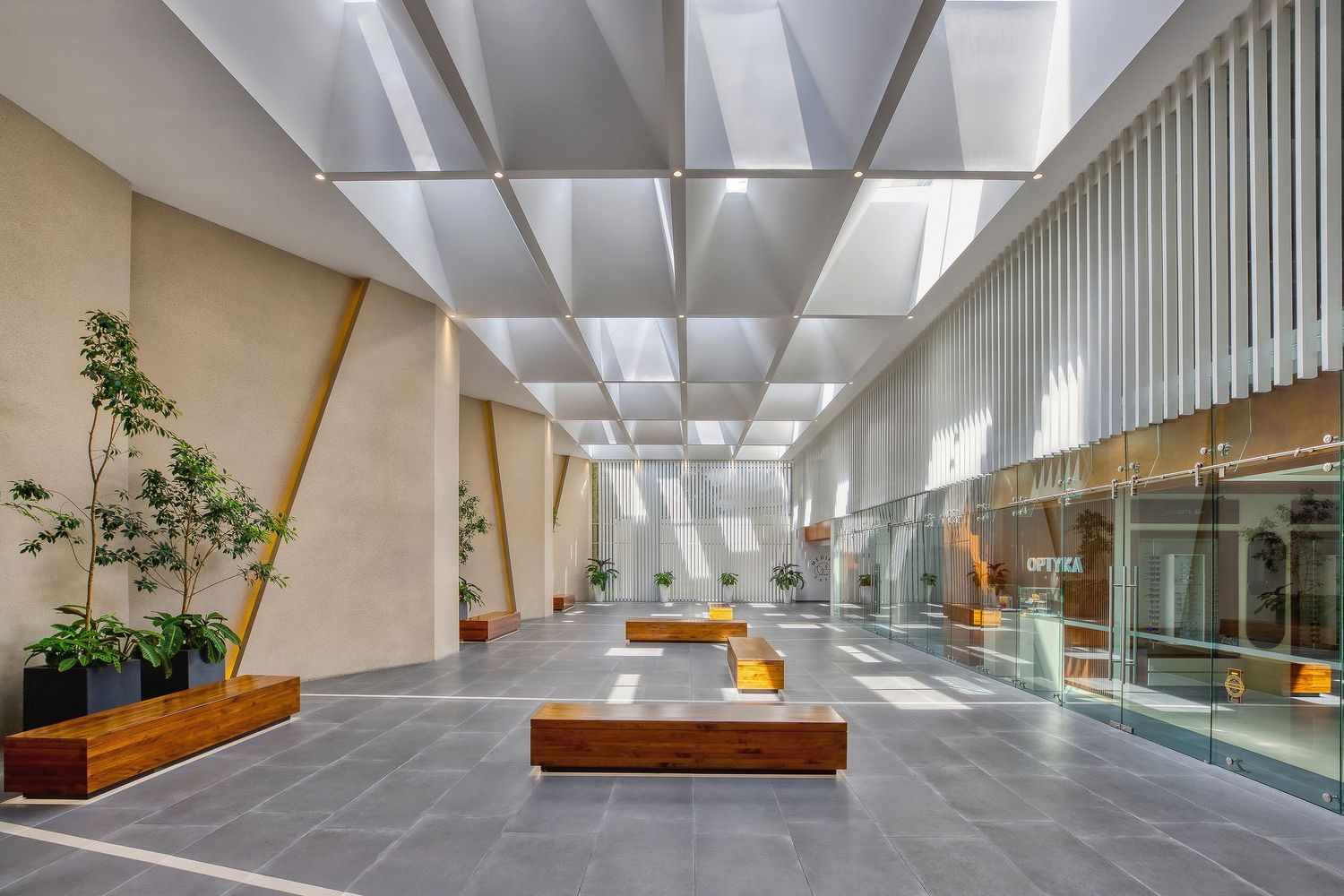 Fotografía de arquitectura. Plaza comercial y vestíbulo de clínicas médicas con pasillos amplios, mobiliario moderno e iluminación natural.