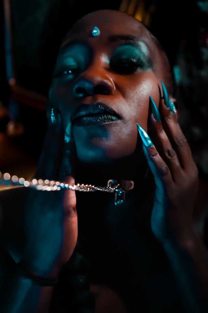 Set of 8 dark atmospheric portrait photos with blue lighting showing close-up facial expressions and hands in motion.