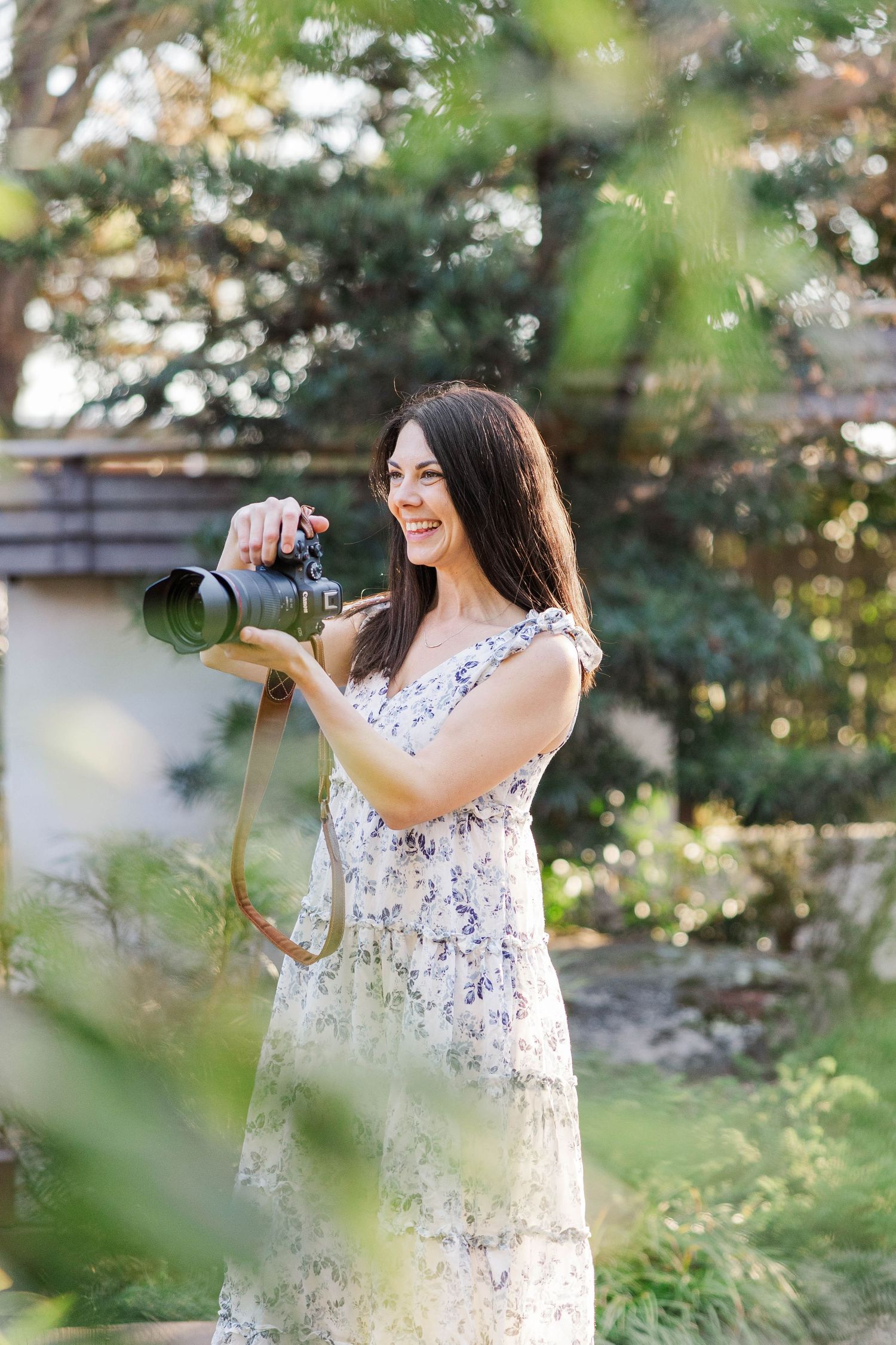 A Raleigh photographer, Jessie Peloso Photography, stands with her camera taking a photo