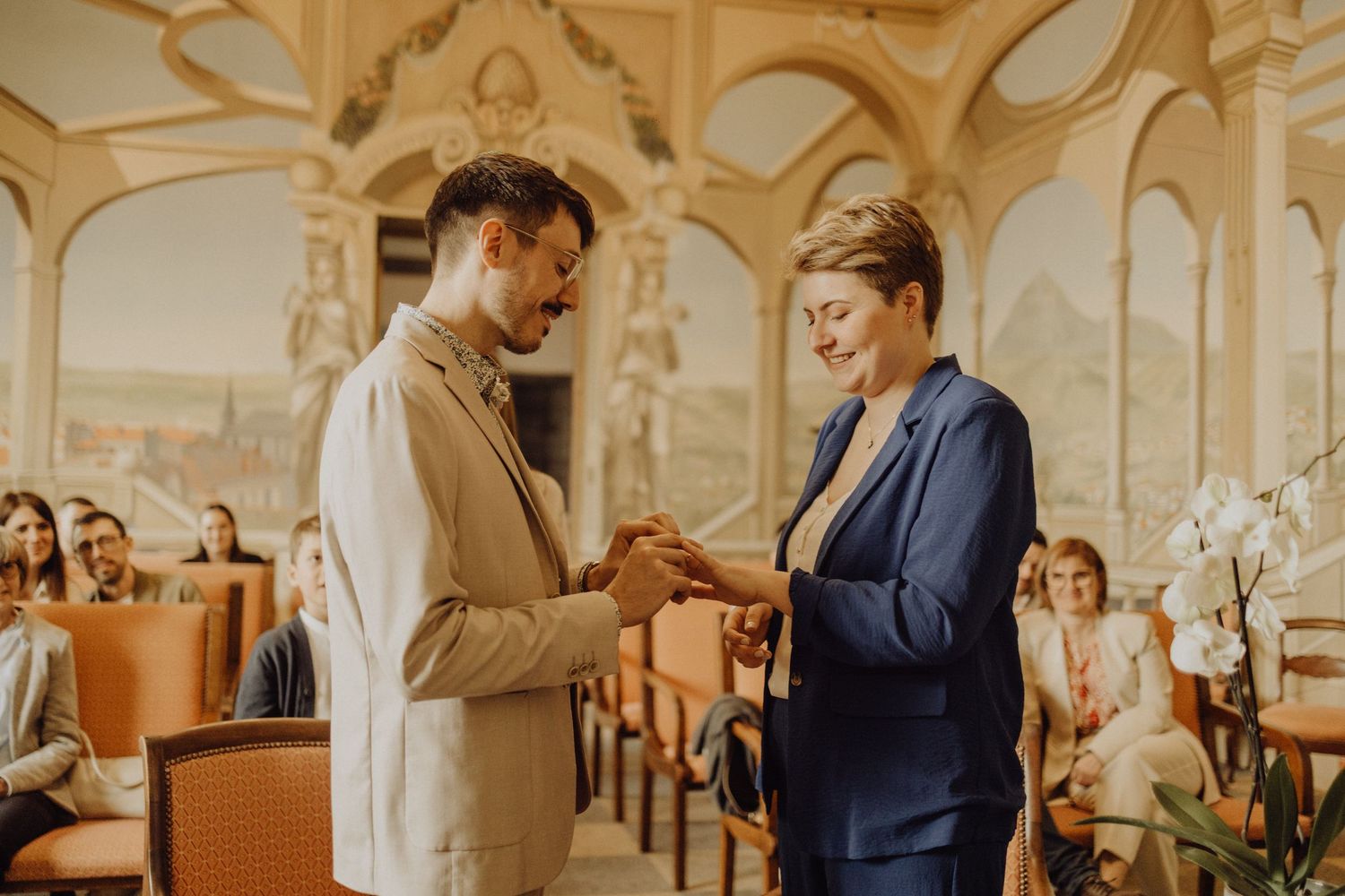 Elegant wedding ceremony in a grand historic church with arched ceilings and warm lighting.
