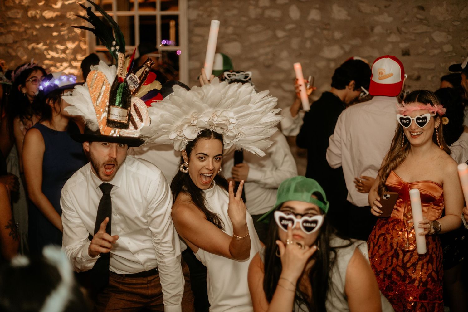 People dancing and celebrating at a lively party wearing sunglasses and casual attire.