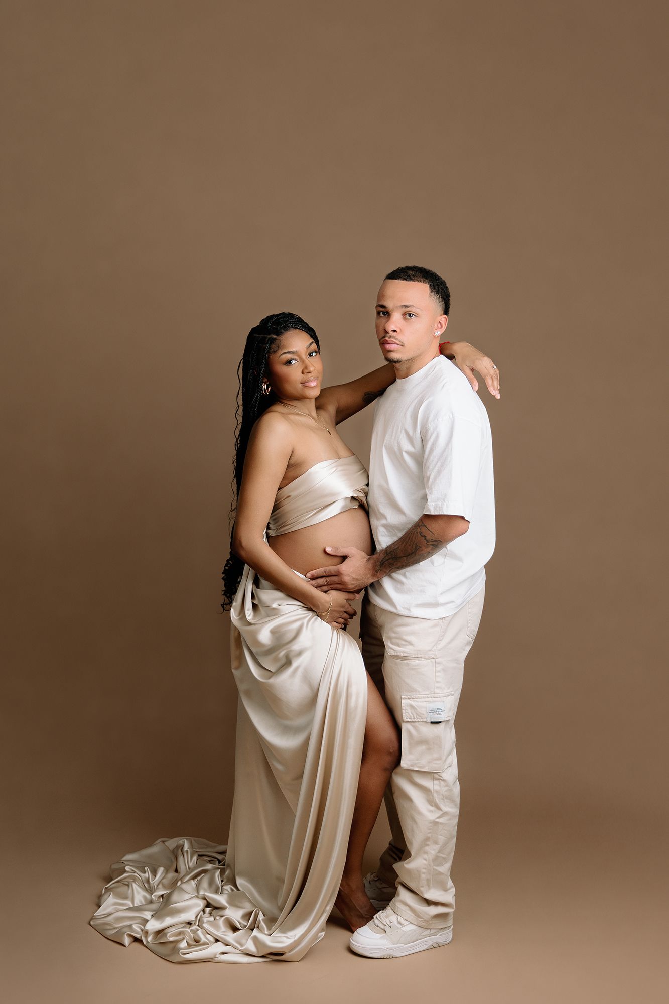 editorial style studio maternity photo of pregnant mom posed with partner