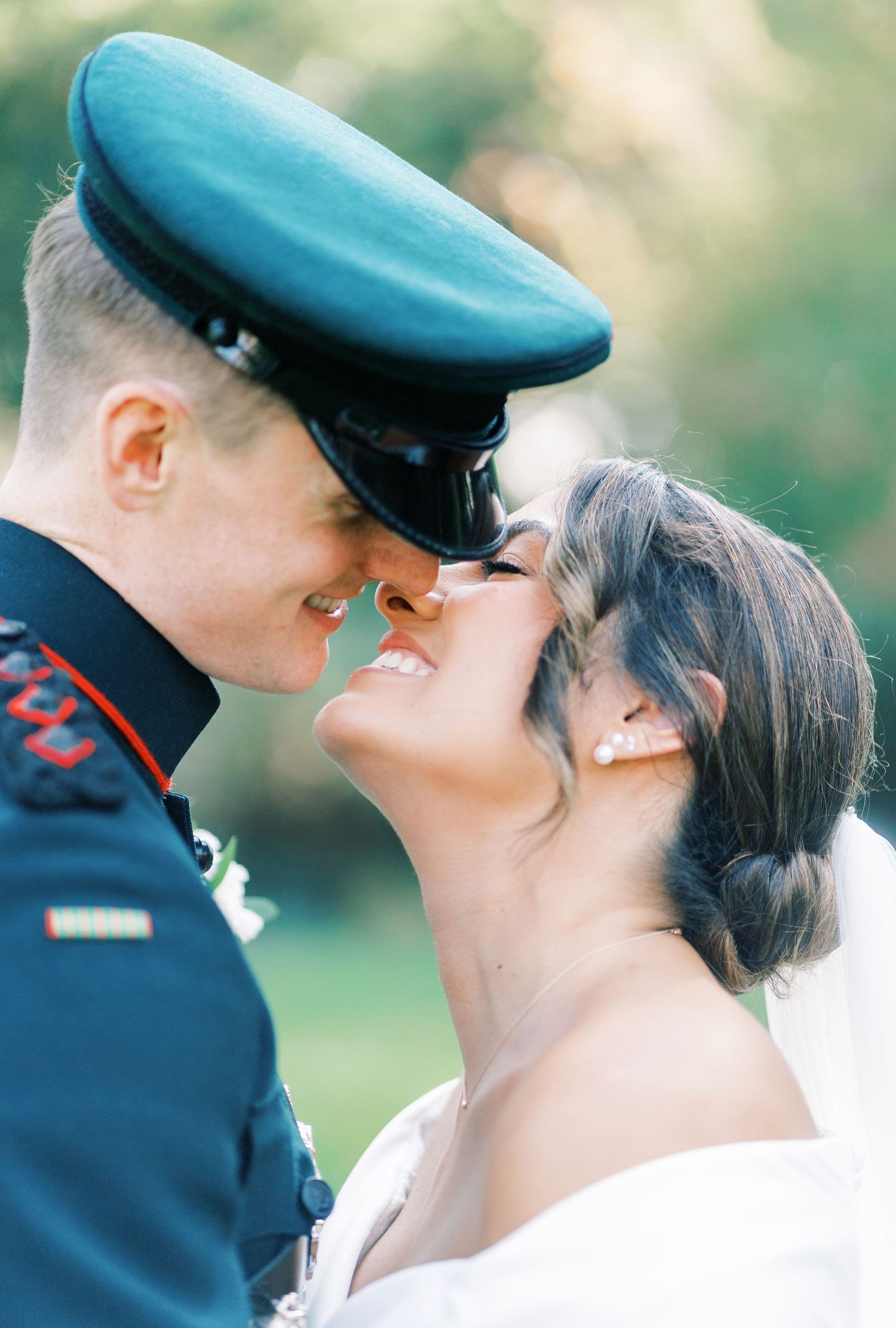 A military couple shares an intimate moment during their wedding ceremony.