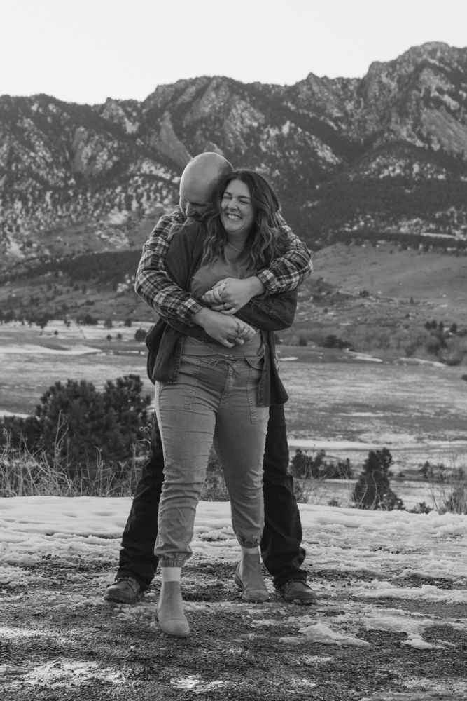 A couple embraces in a romantic photoshoot against a scenic mountain backdrop | Westminster, CO motherhood & family photographer