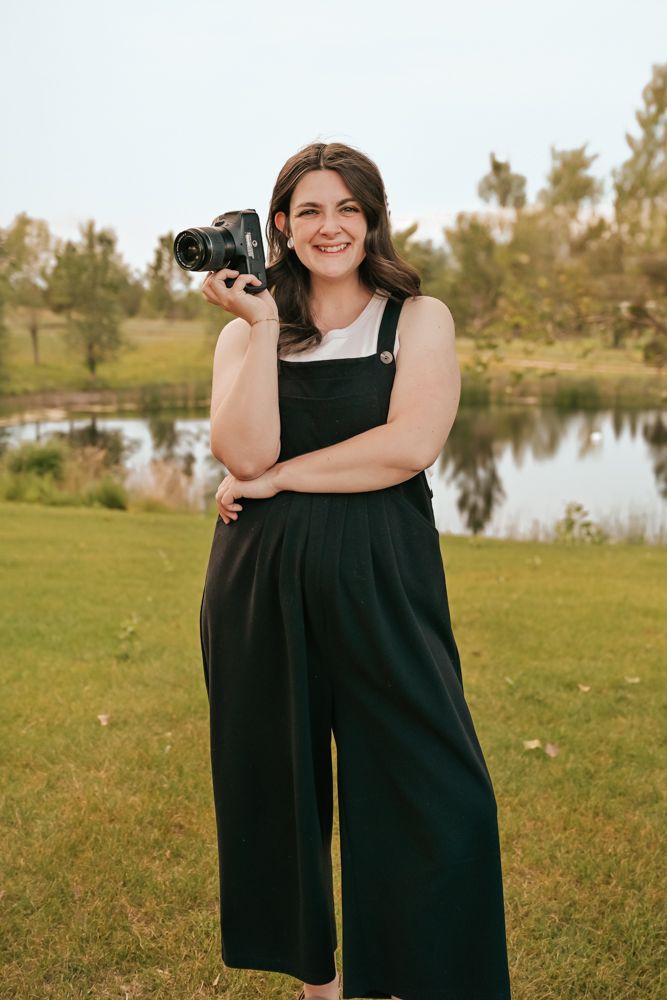 Rachel Raymond the face on honey and friends photography standing with her camera happy to capture moments for your family