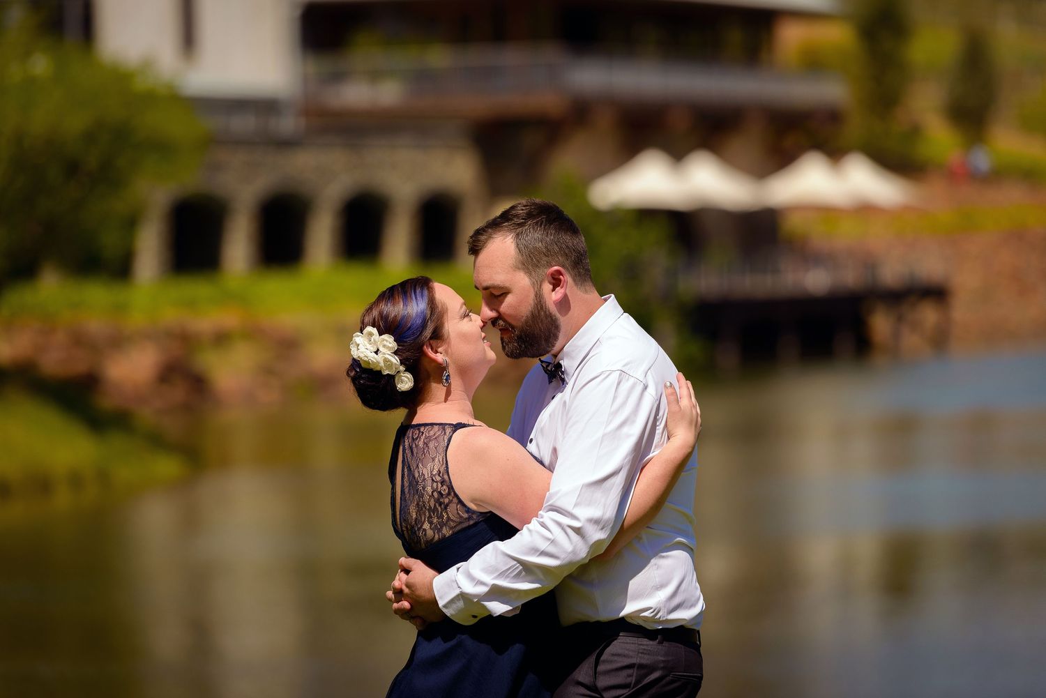 Wedding photo of bride and groom hugging in front of a lake - Kelly Chapman Photographer Perth