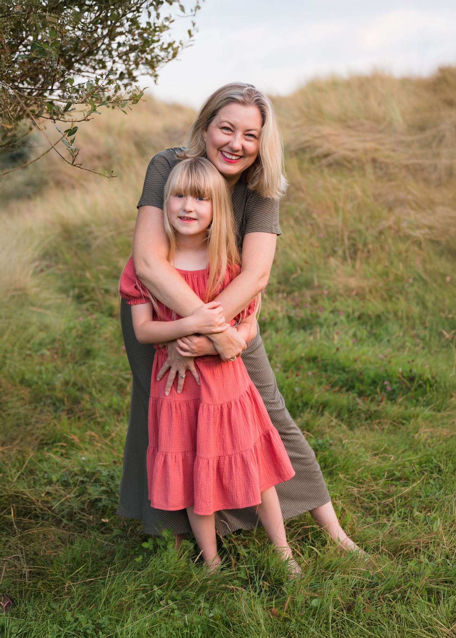 Candid family moments captured in grassy outdoor setting.