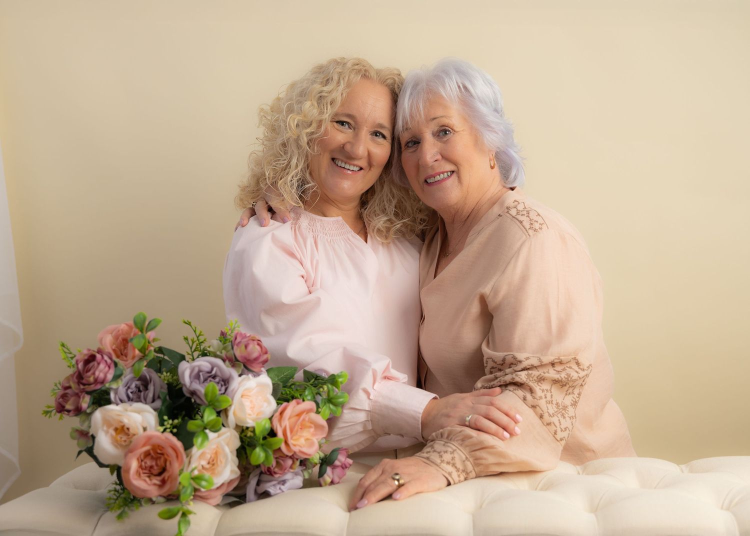 Soft pastel portrait series with floral arrangements and cream colored background.