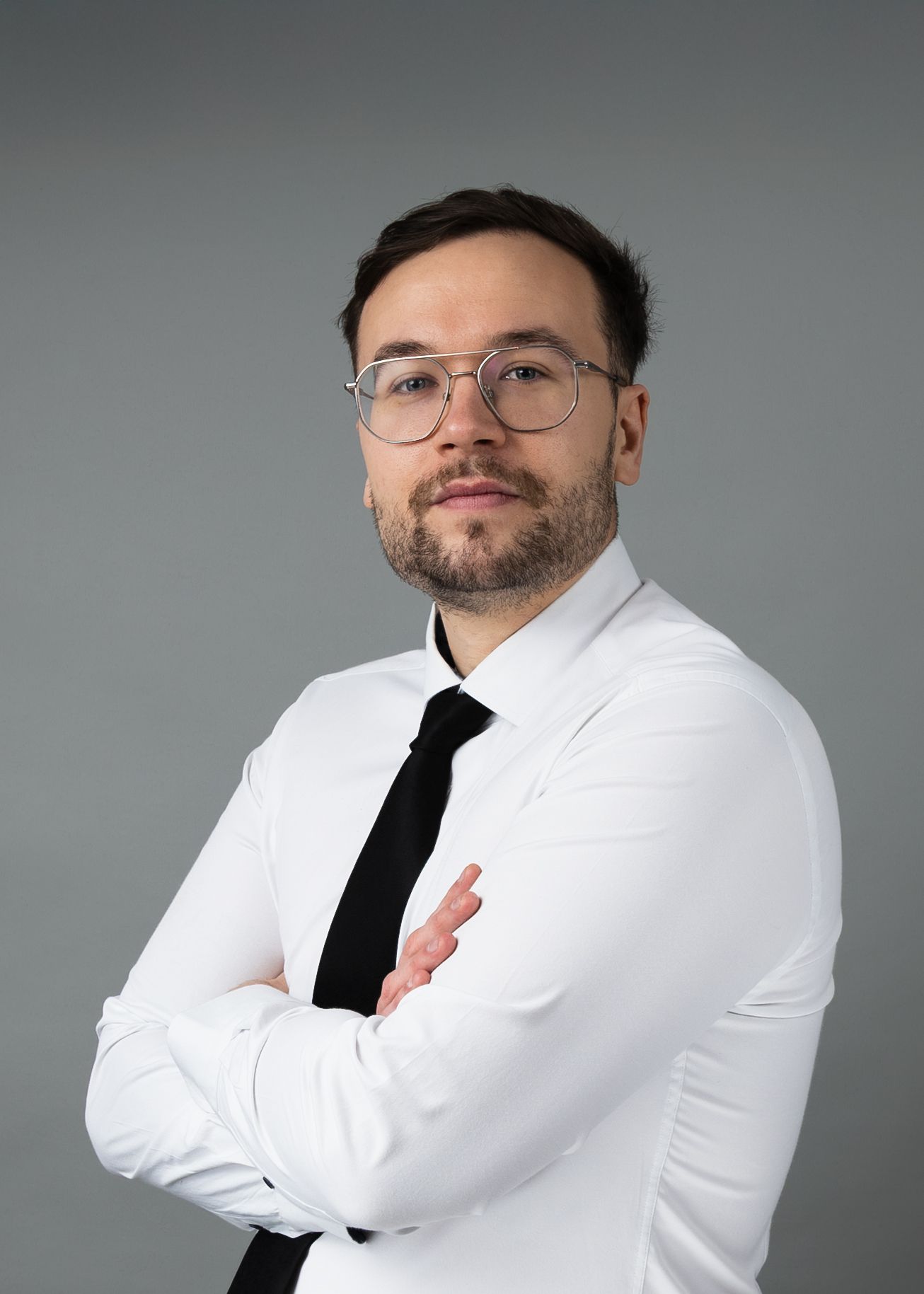 Professional headshot series showing a person in a white dress shirt and black tie against a gray background.