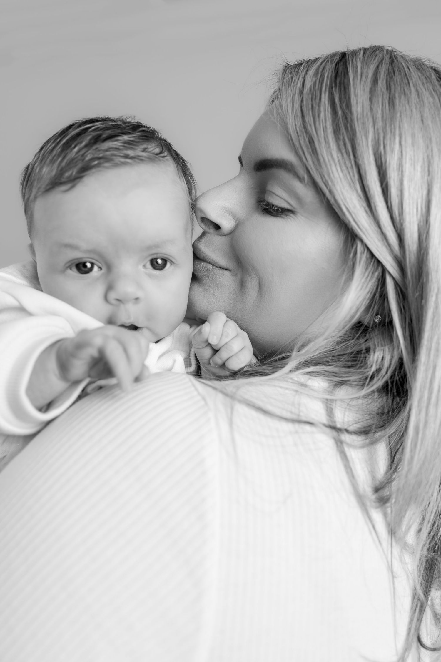Black and white intimate portrait series showing tender moments between parent and child.