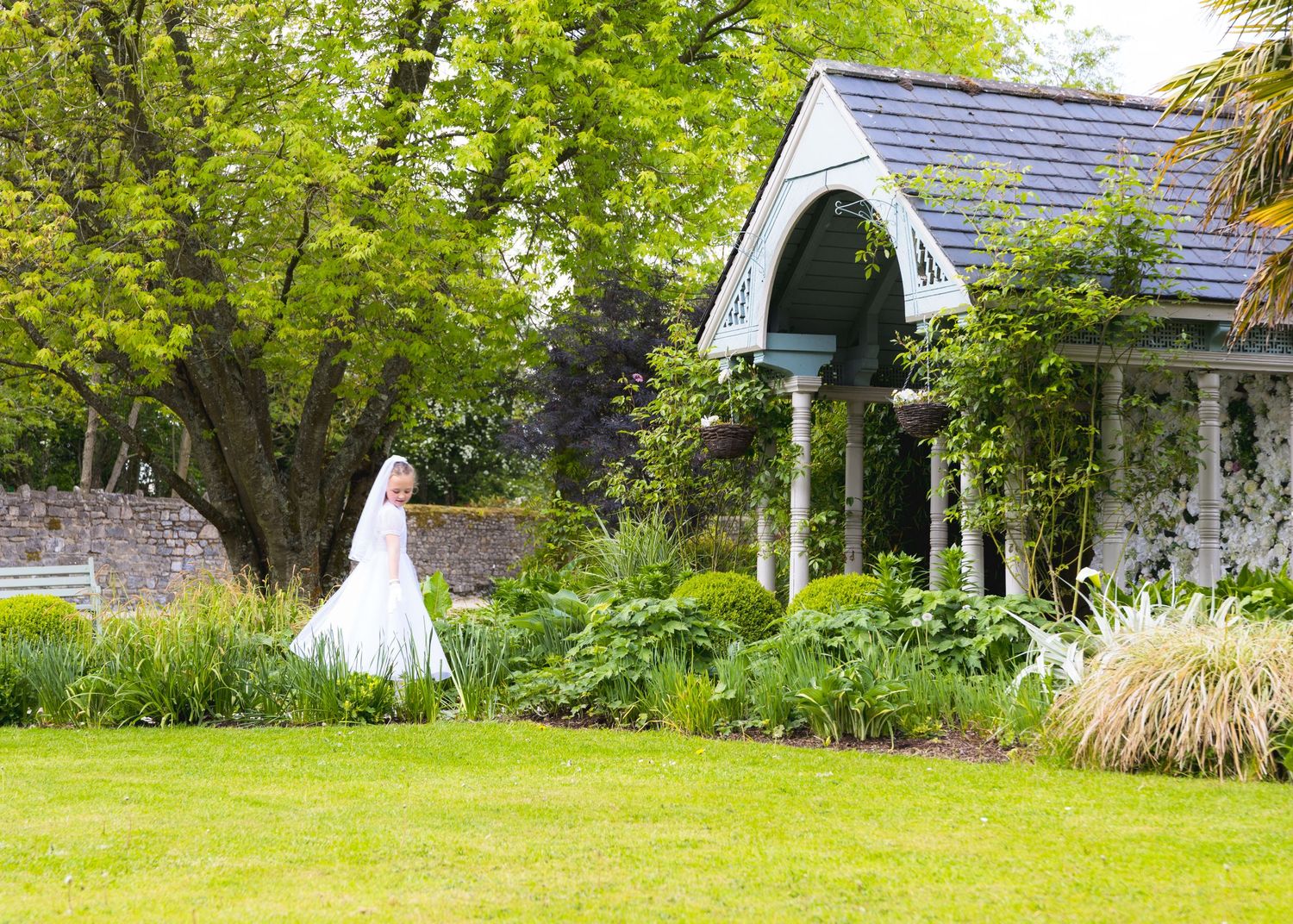 Landscape series showing green garden setting with white chapel in background.