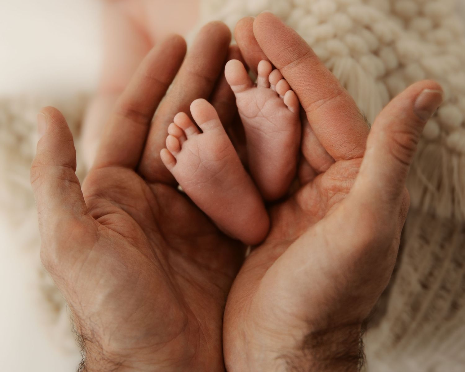 A series of tender images showing a baby's tiny hand grasping an adult's finger in different angles.