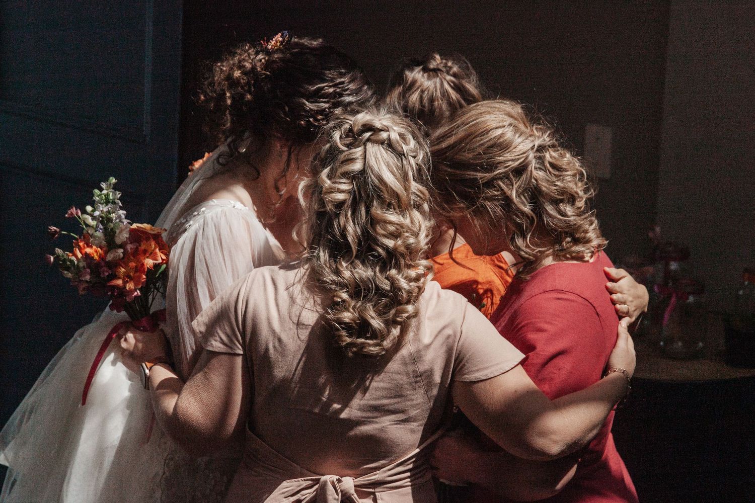 A romantic wedding scene shows couples embracing in an intimate indoor setting with soft lighting and floral decor.
