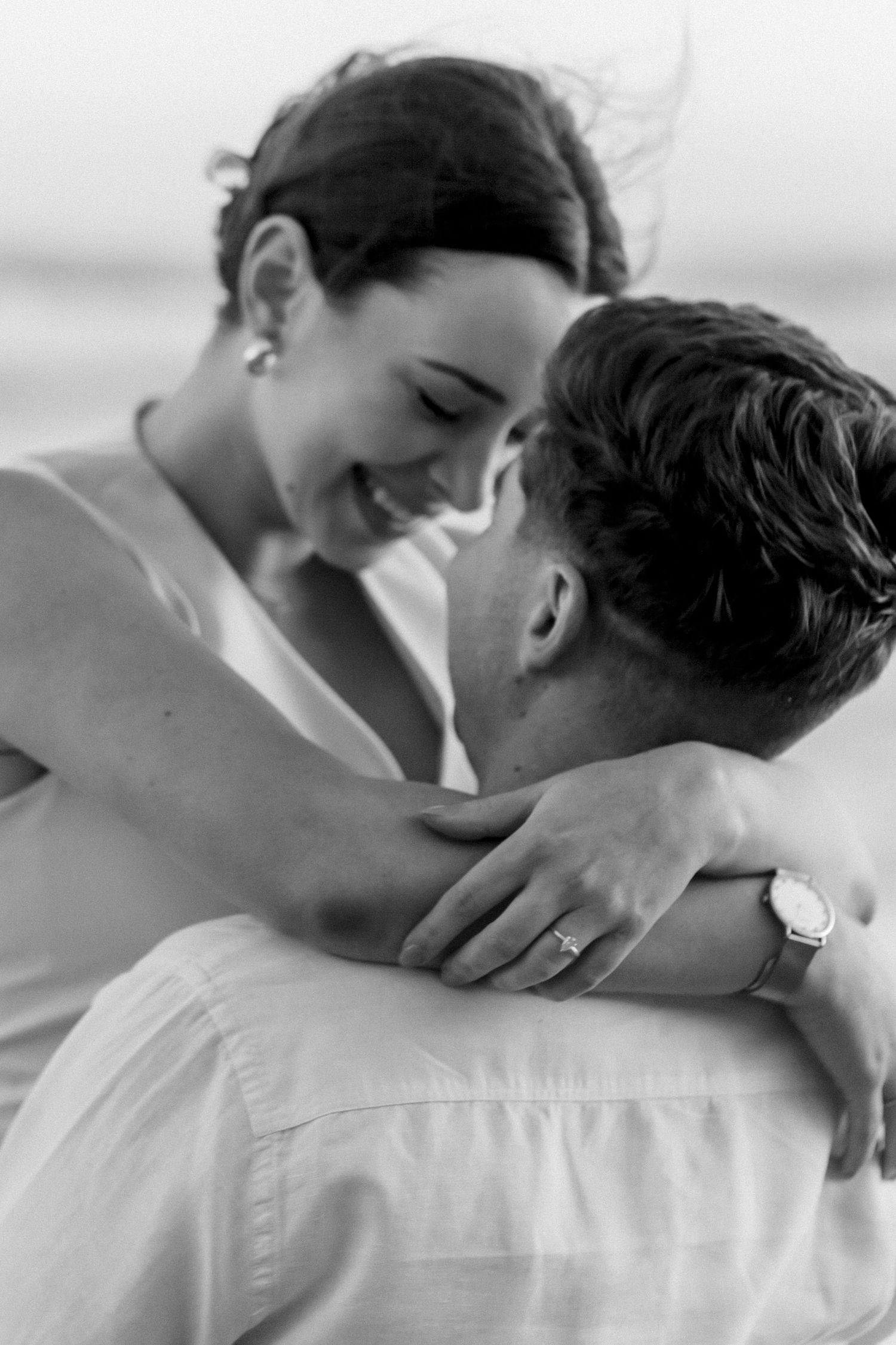 A series of romantic black and white photos showing an intimate embrace between two people.