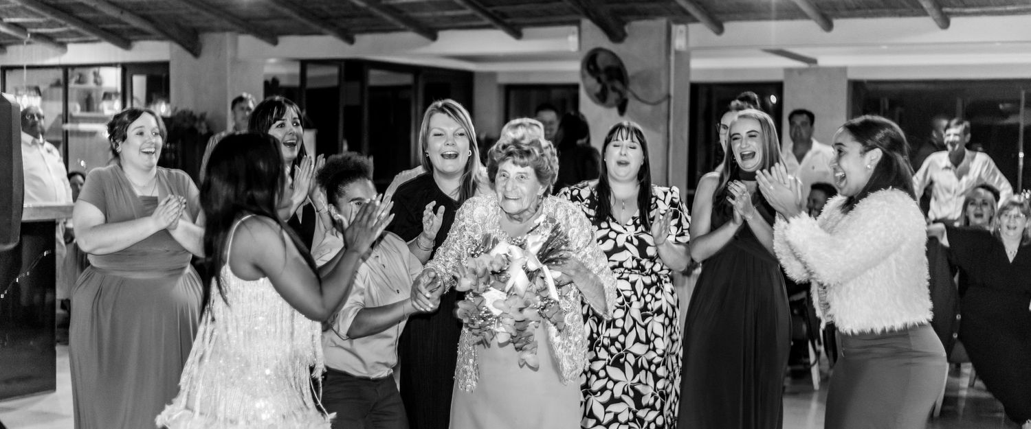 Black and white photo montage of people dancing and celebrating at a wedding reception.