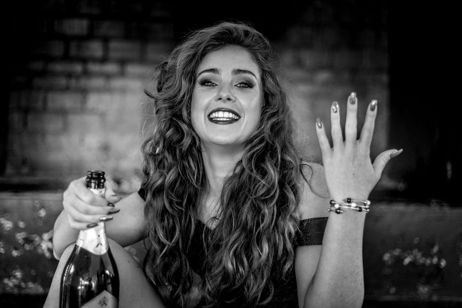 A black and white collage of candid laughing expressions showing joy and natural emotion.