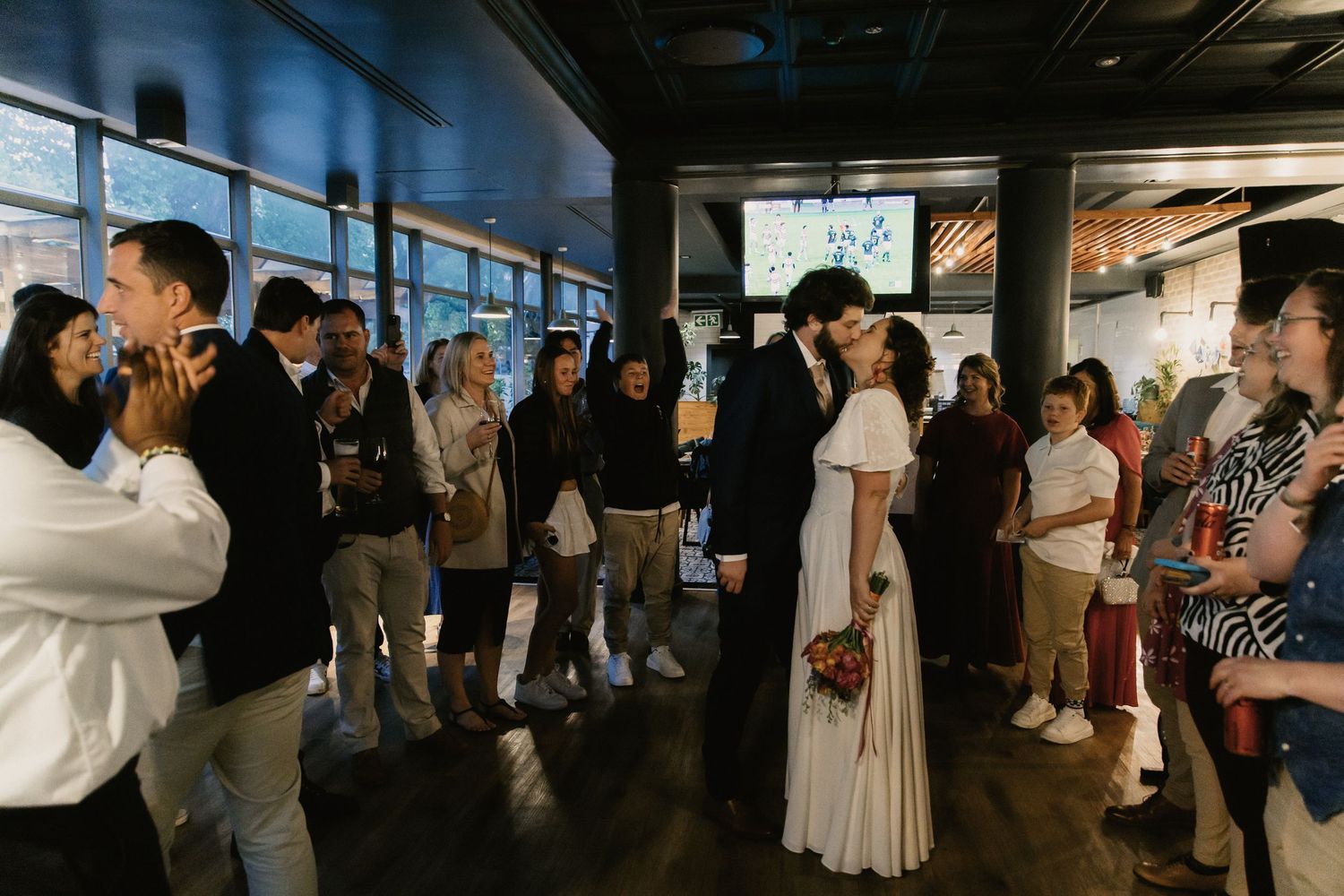 Couples dance together in a dimly lit indoor venue during what appears to be a social dance event.