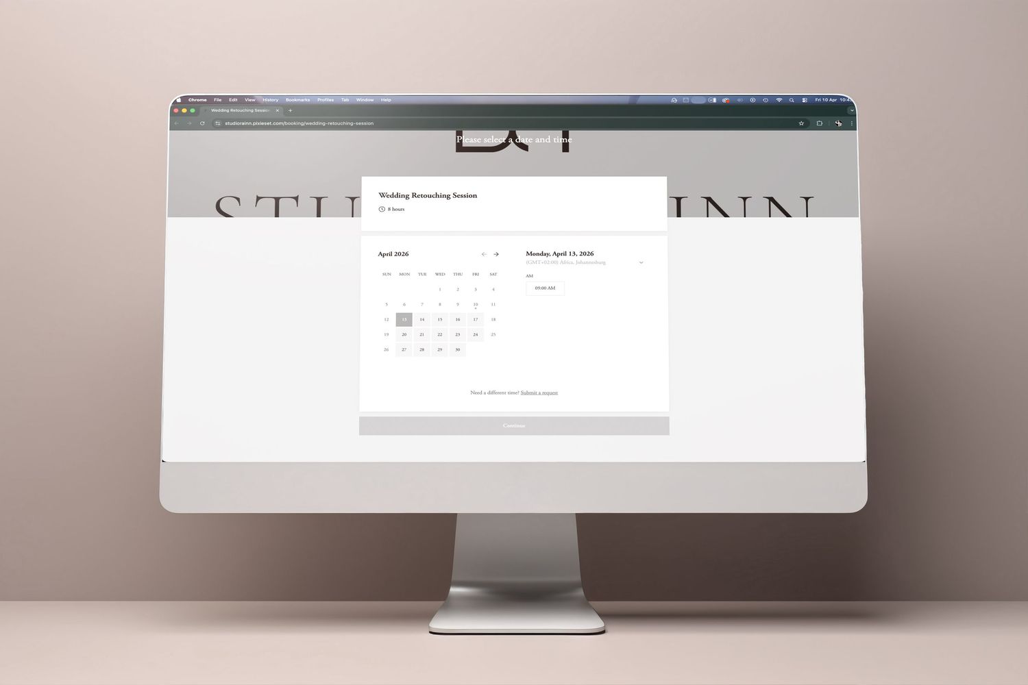 A desktop computer displaying a wedding scheduling website with a calendar booking interface on a neutral background.