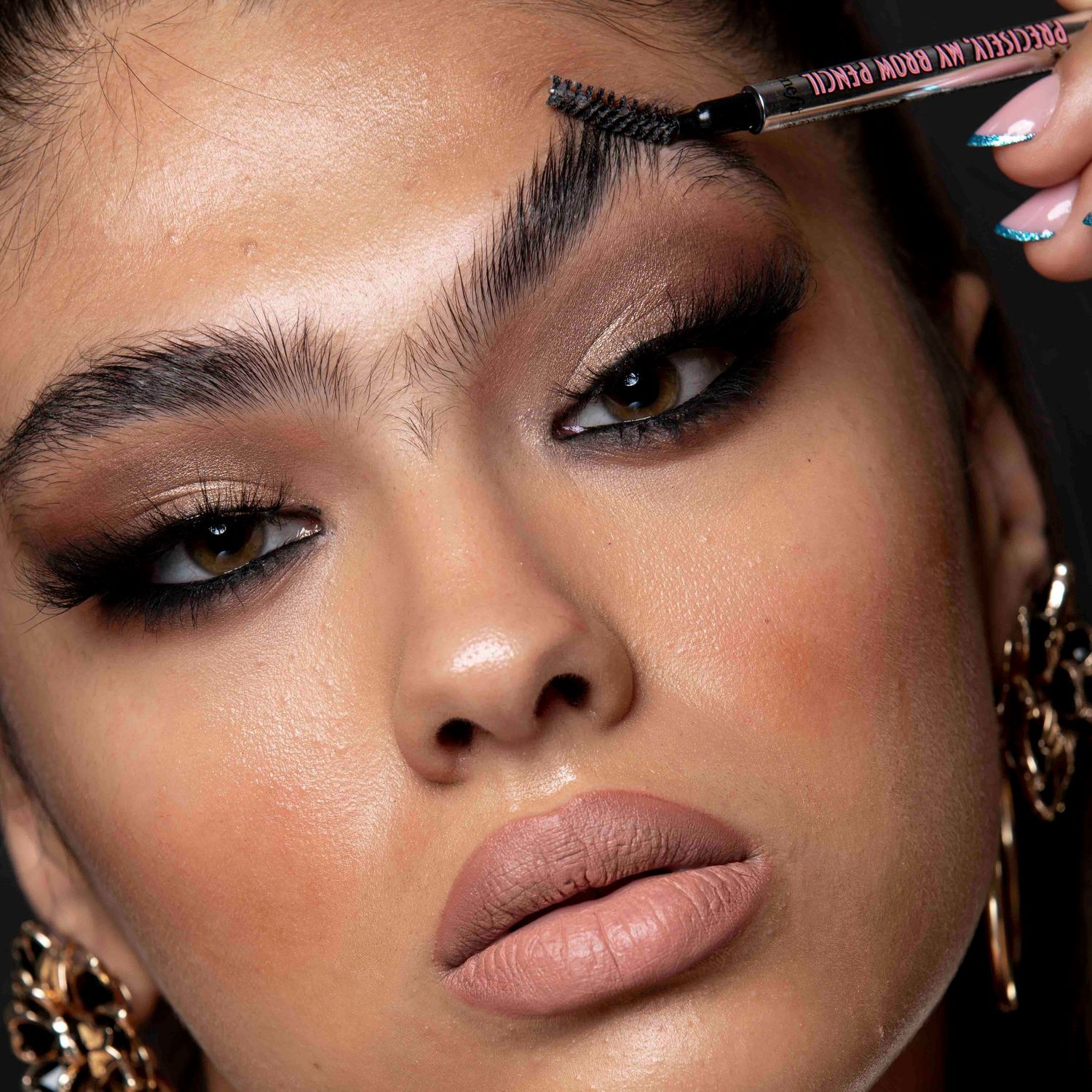 Artistic beauty portrait highlighting dramatic eye makeup and perfectly styled brows.