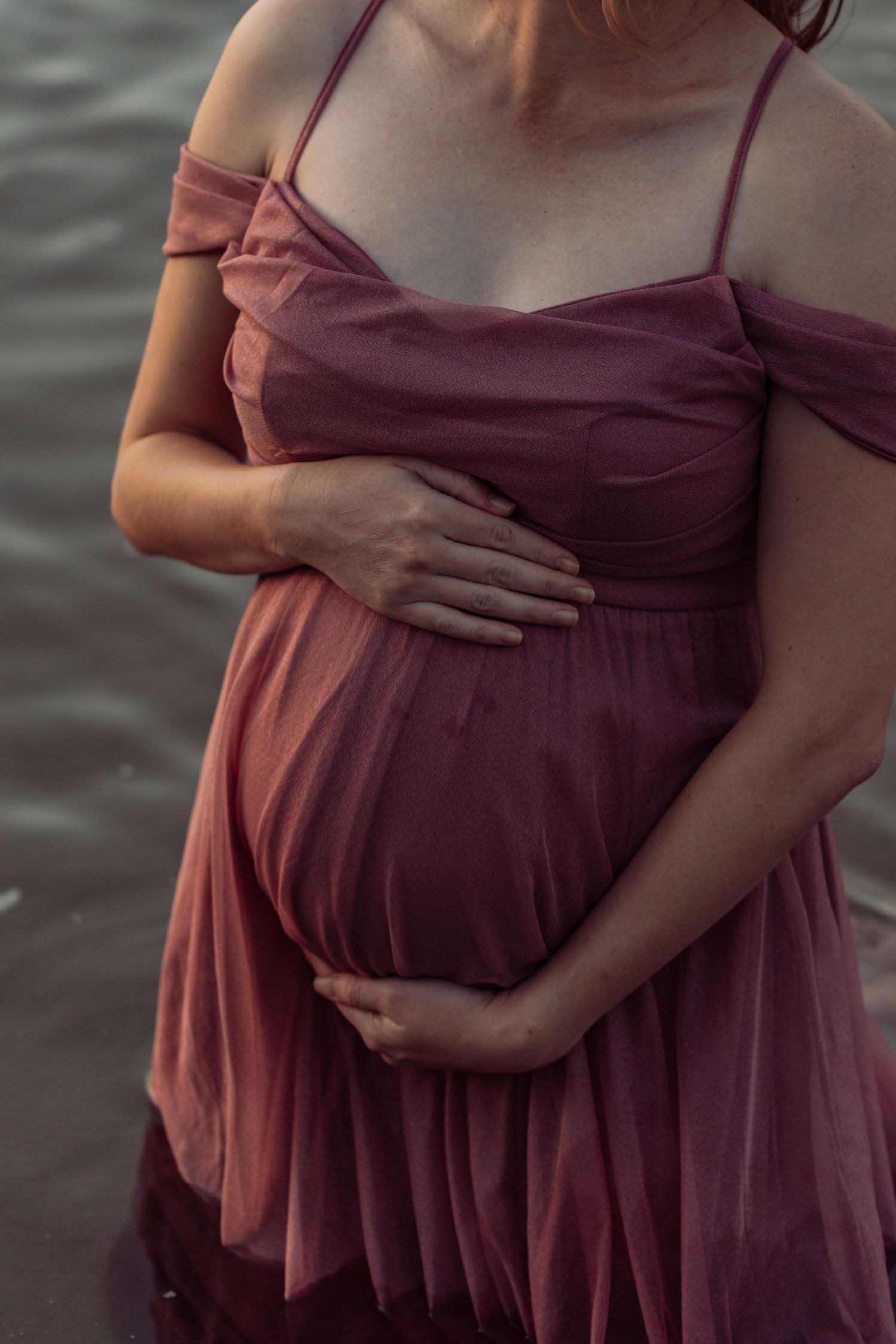 A series of cropped photos showing a person wearing a burgundy dress gently cradling their pregnant belly.