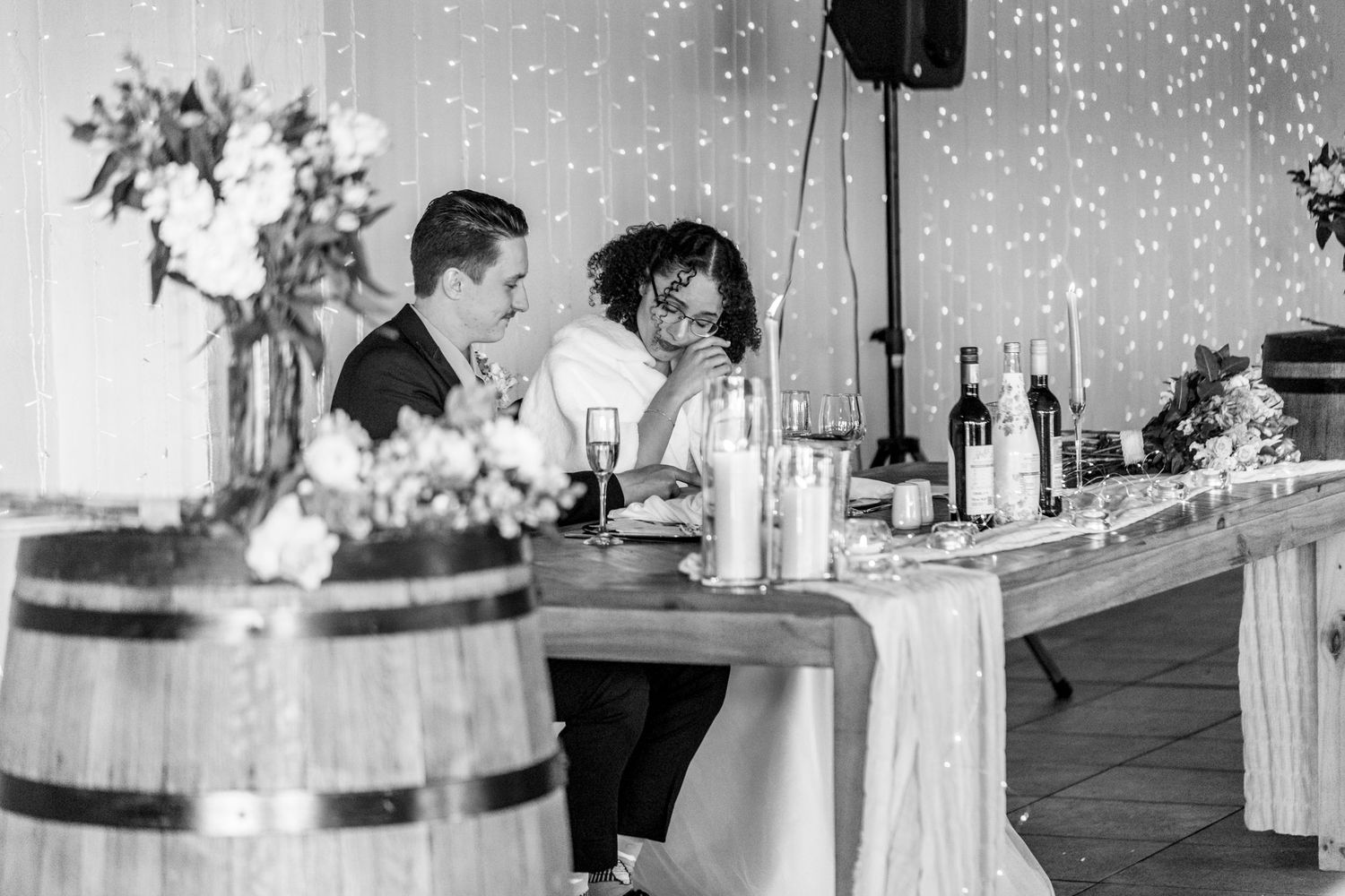 A series of black and white photos showing a wedding reception celebration with guests dancing and socializing.
