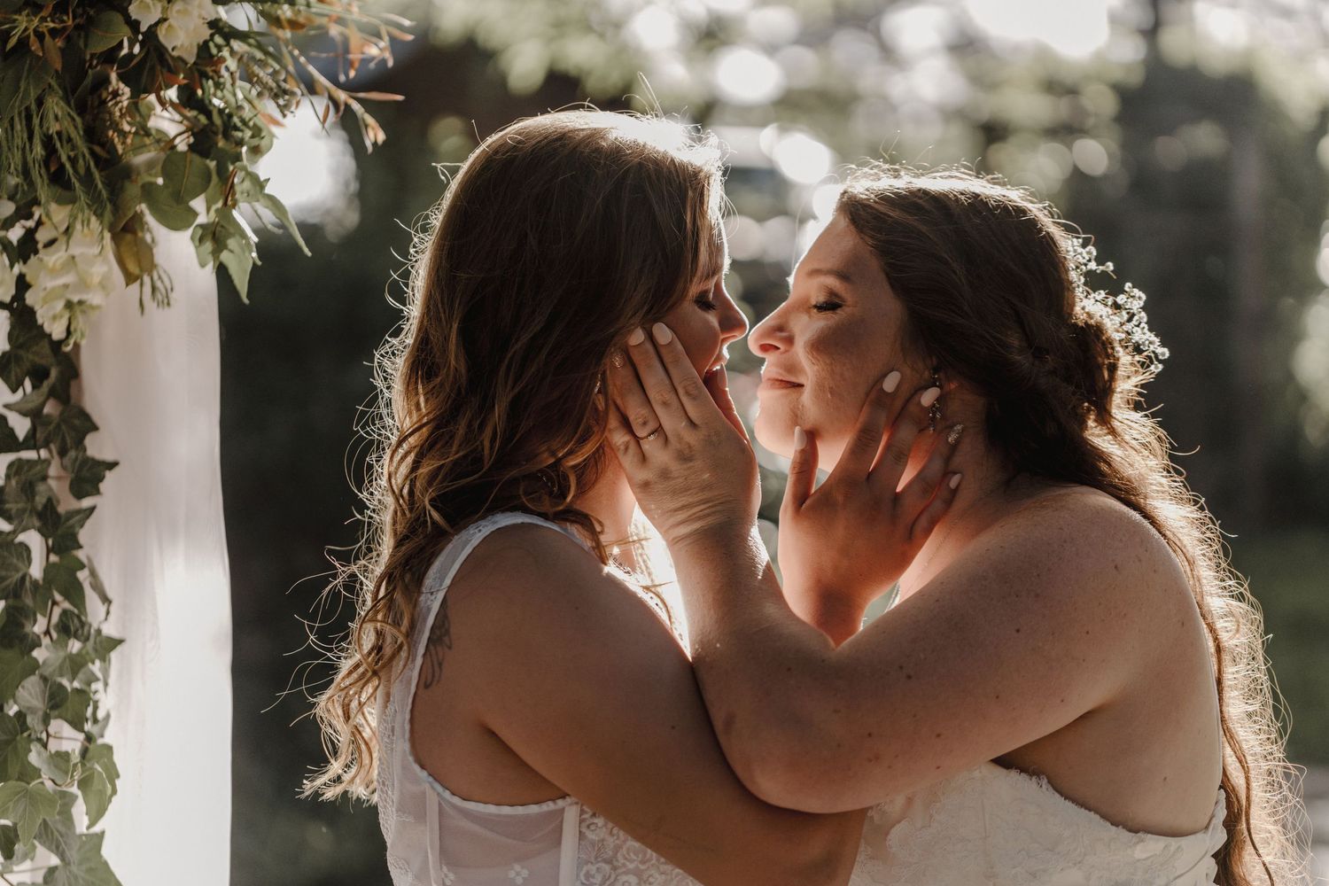 A romantic couple sharing tender moments in a sunlit outdoor setting with white pillars framing the scene.