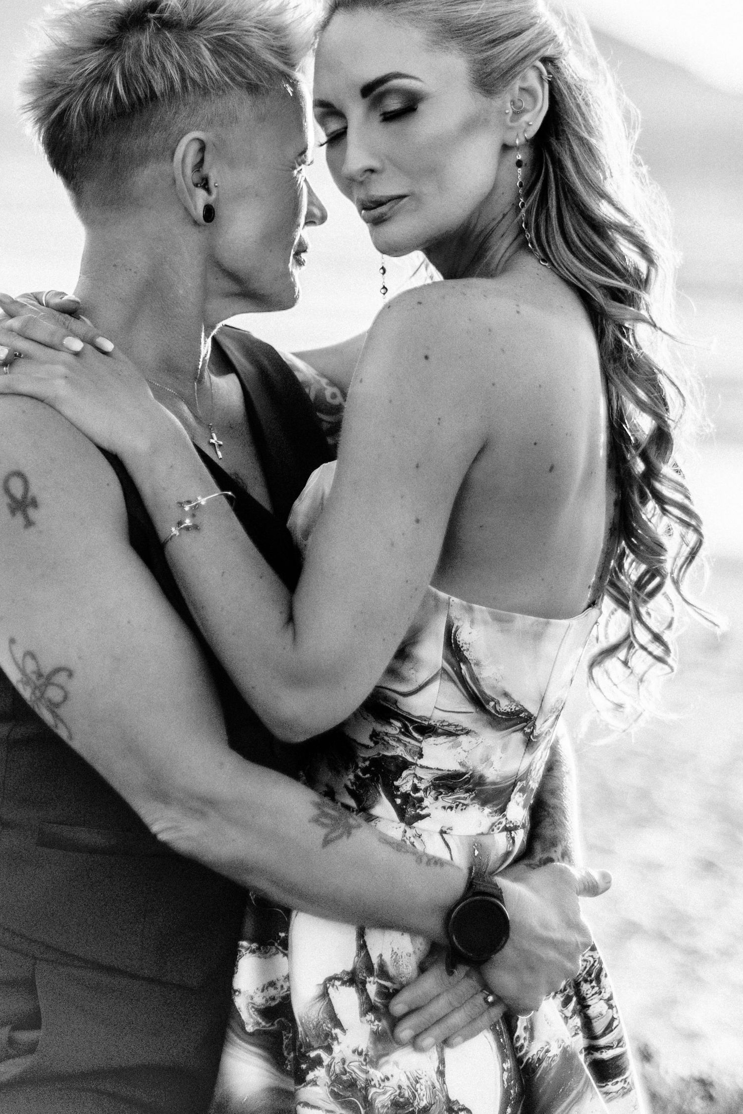 A series of black and white romantic photos showing a couple embracing intimately in an artistic photoshoot.