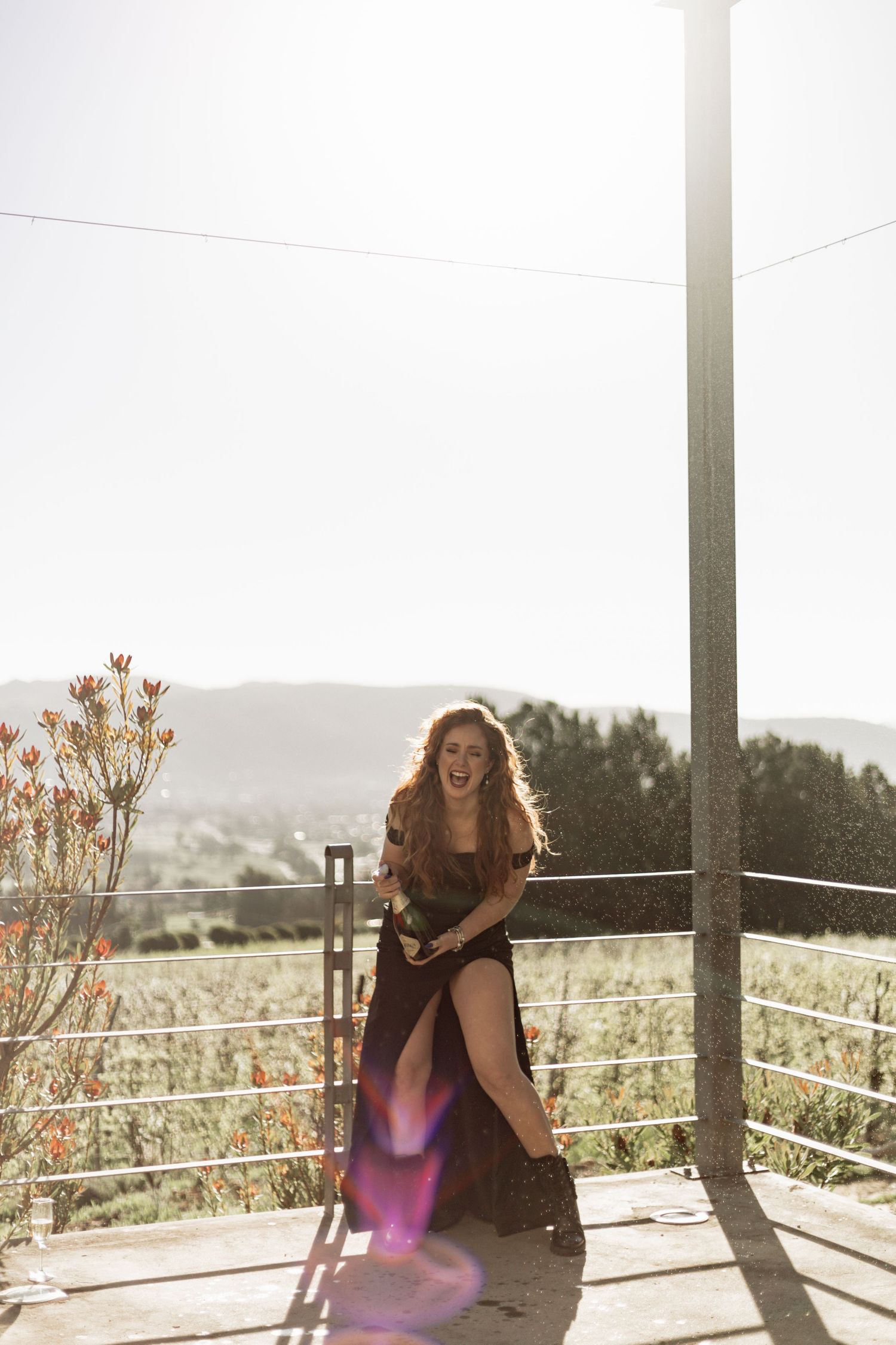 Sun-drenched outdoor portrait series with natural backlight and mountain landscape in background.