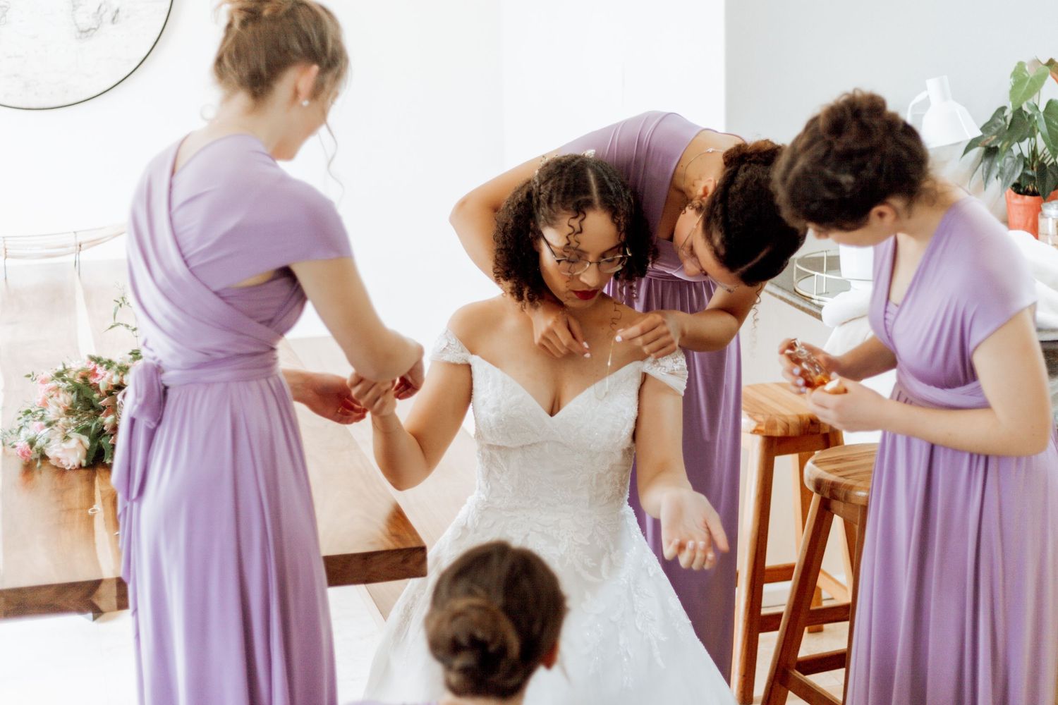 A collection of people in lavender dresses getting ready for a formal event, shown in multiple candid shots.