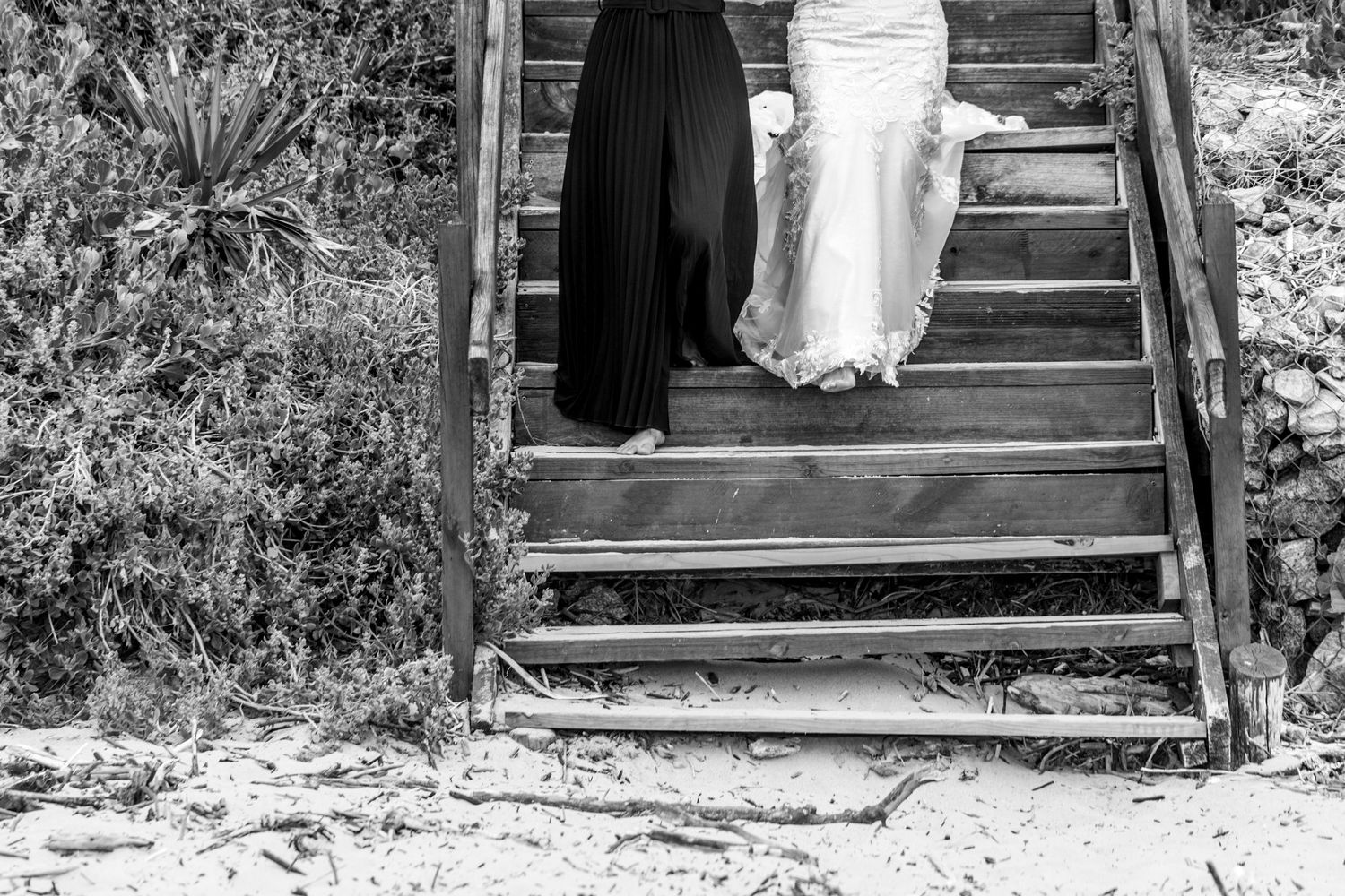 A black and white photo series showing part of a wedding gown and stairs in a rustic outdoor setting.