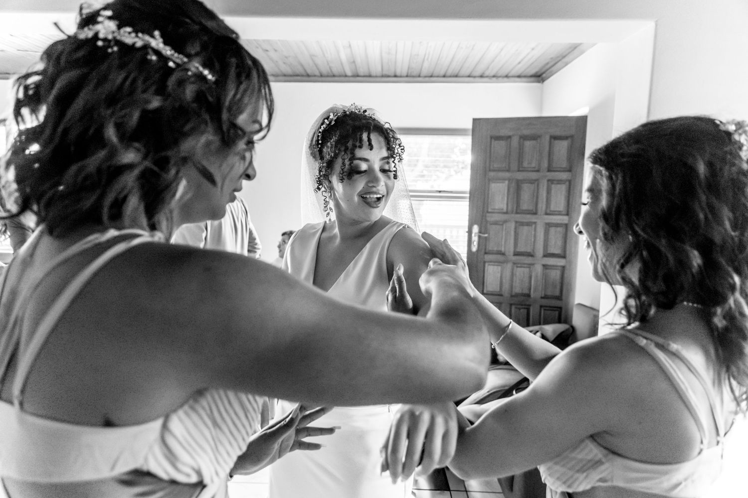 A series of black and white photos showing preparations for a wedding event with curl styling and hair grooming.
