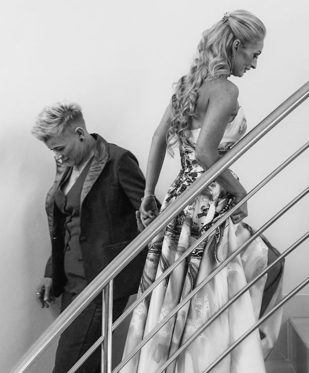 A black and white photo sequence showing a person in formal attire descending a staircase while waving.