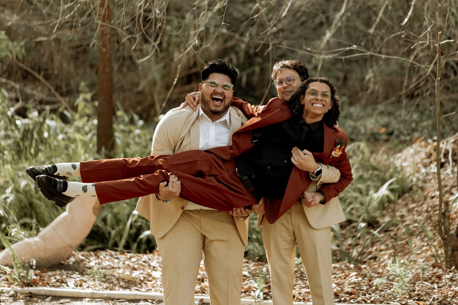 A joyful couple laughing and playing together during an outdoor autumn photo session.