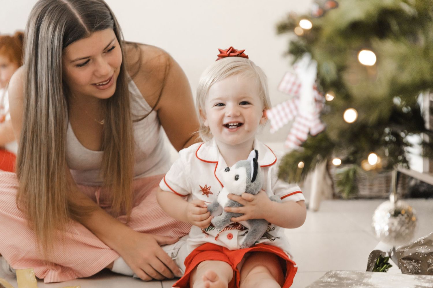 A series of holiday photos showing joyful moments with a baby around a Christmas tree and festive decorations.