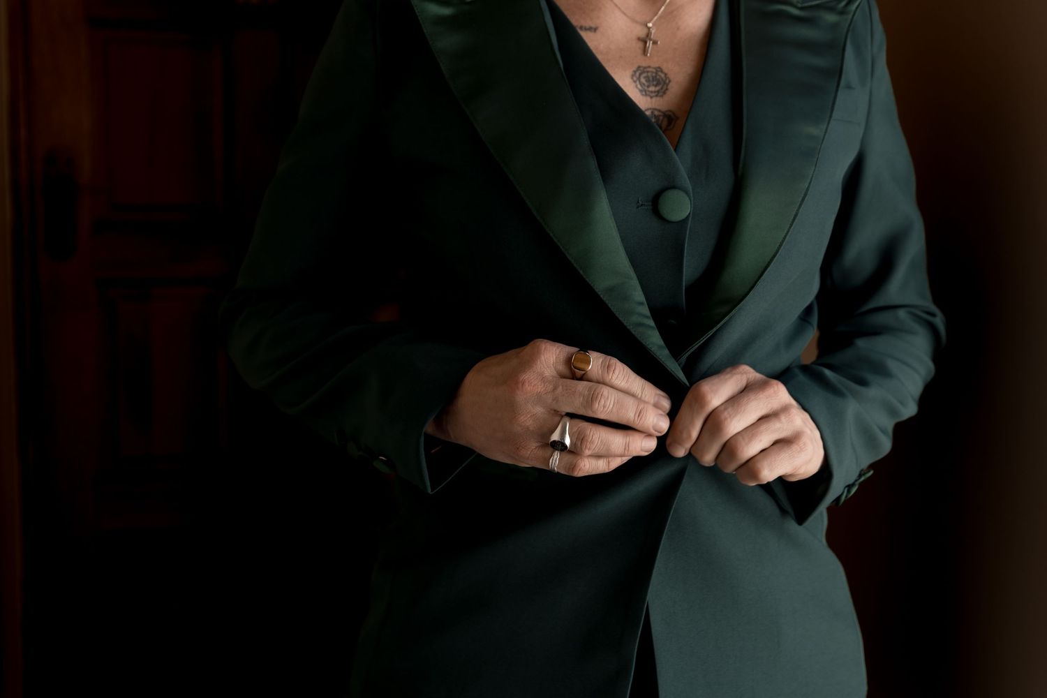 A series of six dark, moody portrait photographs showing someone wearing a green blazer in different poses.
