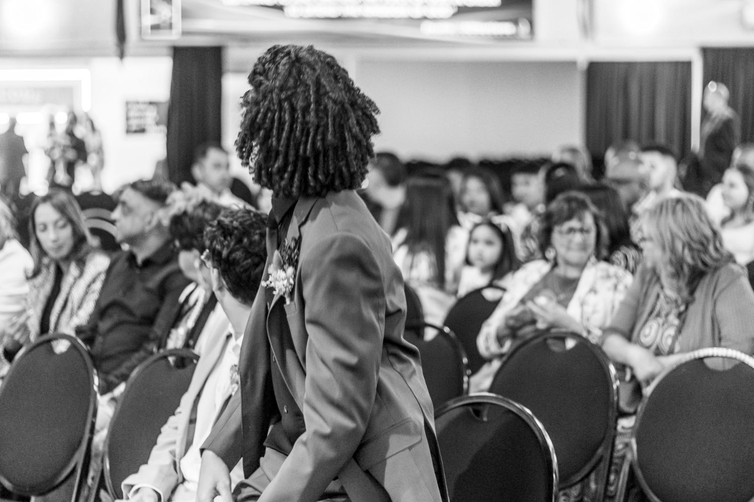 A black and white photo collage shows diverse crowds of people attending professional events and presentations.