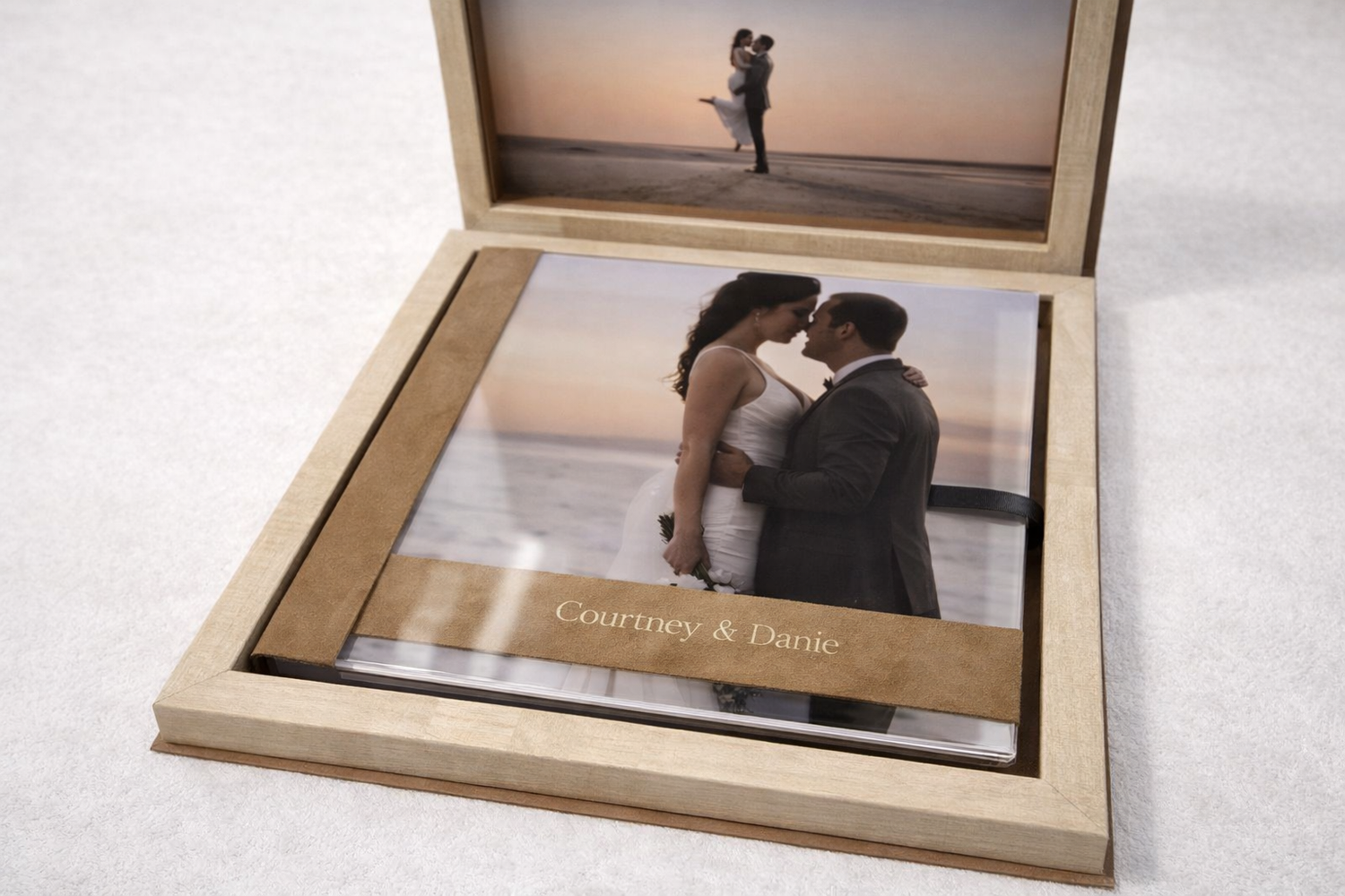 A series of three framed photographs showing a couple's intimate moments displayed in wooden frames.
