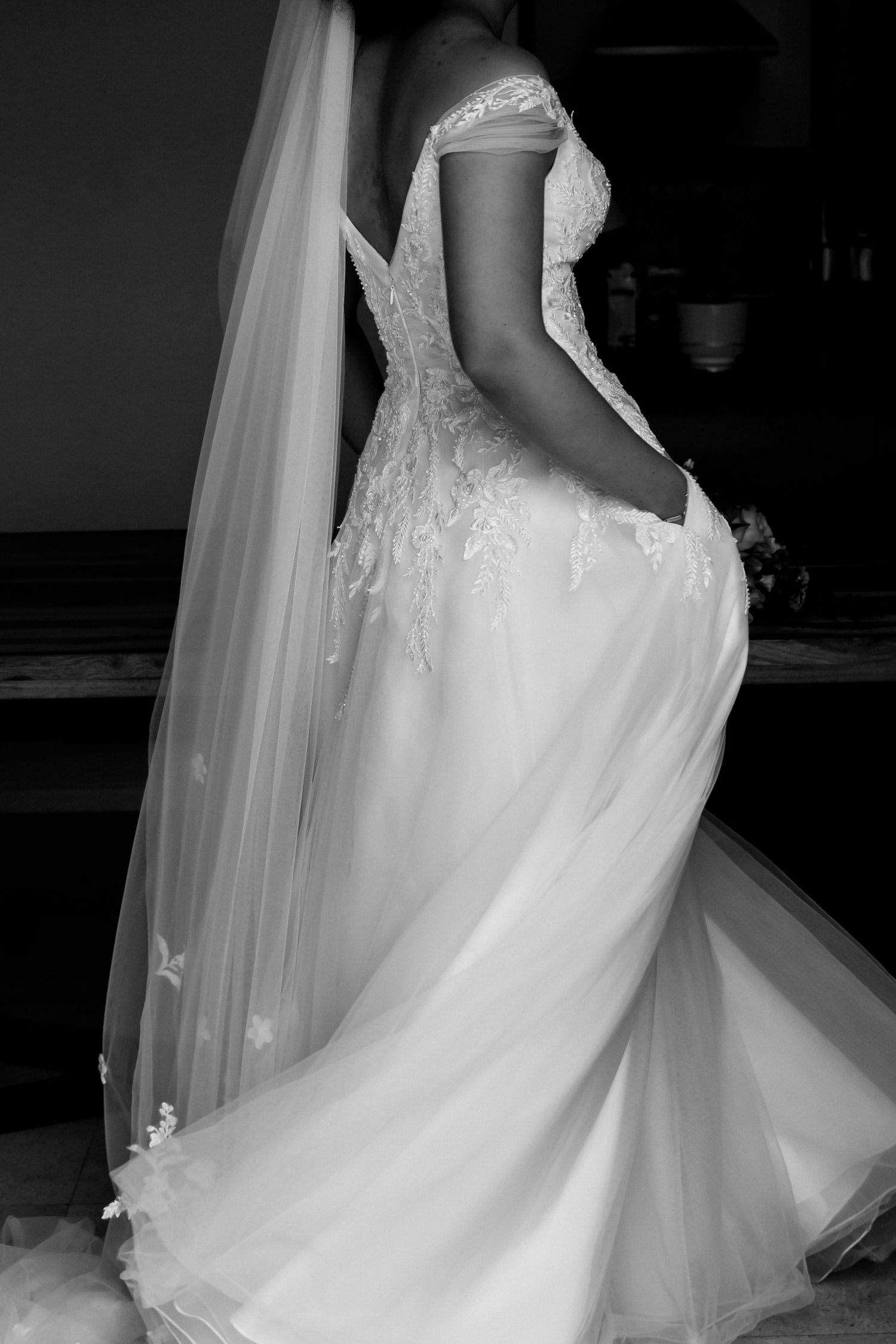Flowing white wedding gown with delicate lace details and tulle skirt shown from multiple angles.
