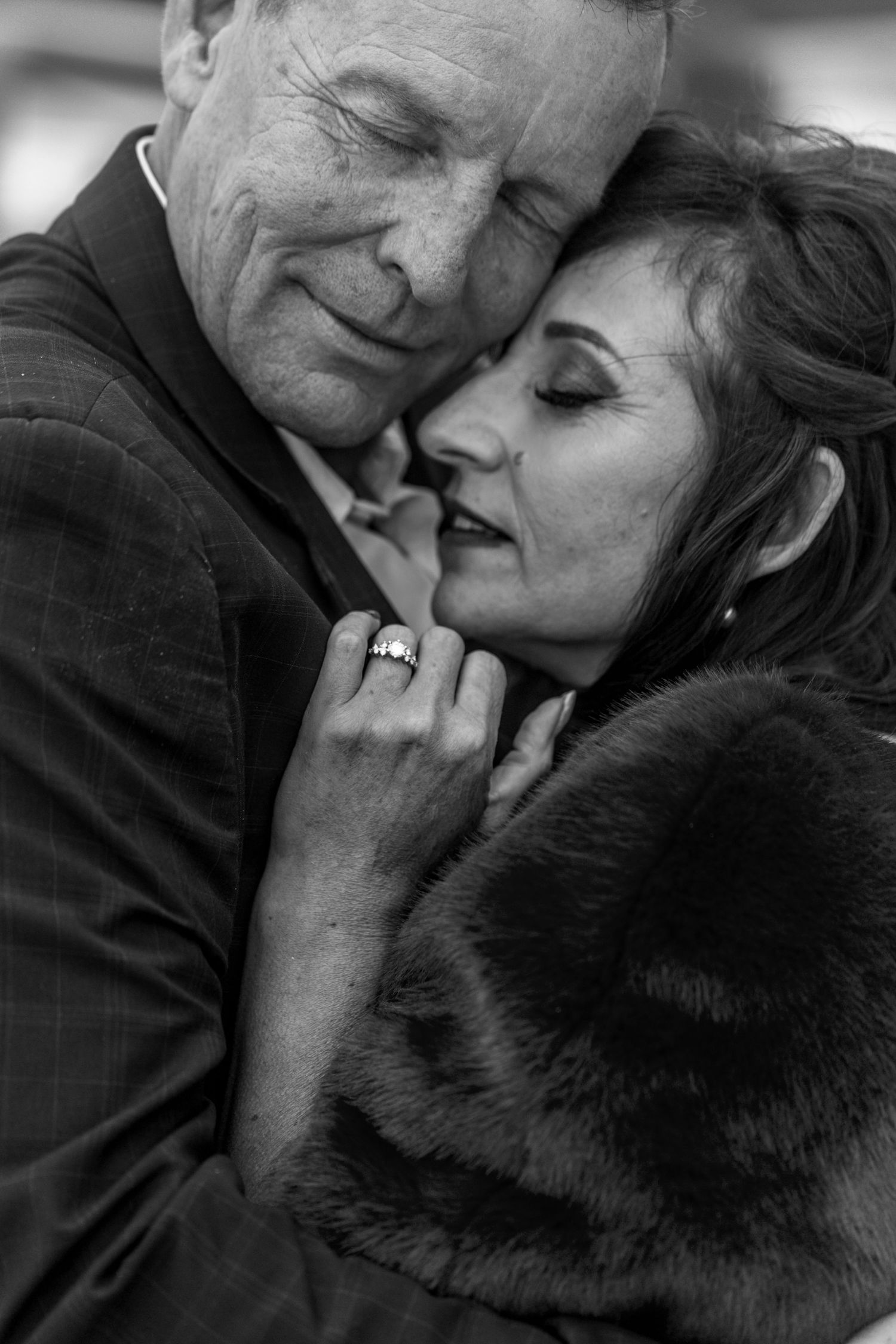 A sequence of intimate black and white photos showing a couple embracing in tender romantic moments.