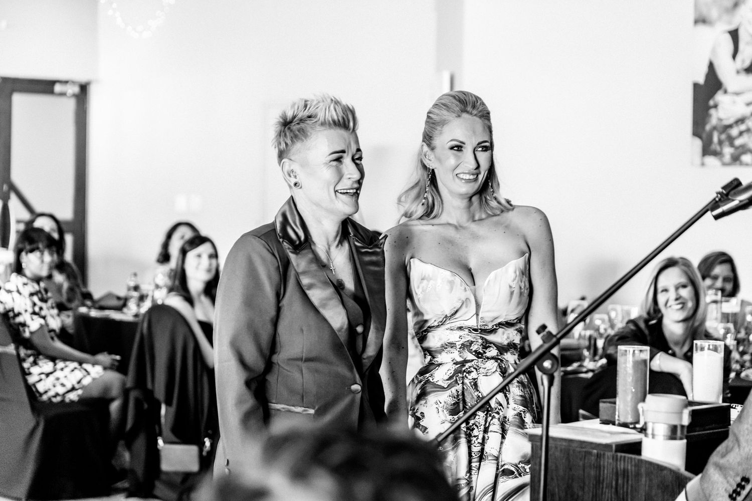 Black and white candid shots of wedding guests celebrating and interacting during a reception.