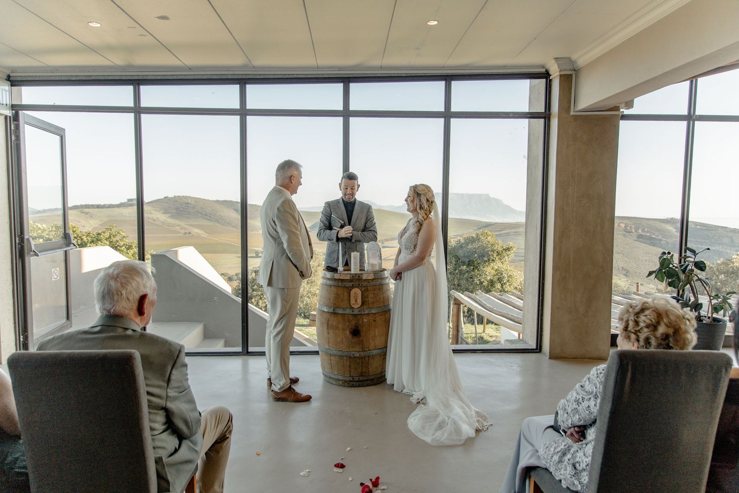 A panoramic view from inside a modern airport observation deck with floor-to-ceiling windows overlooking the runway.
