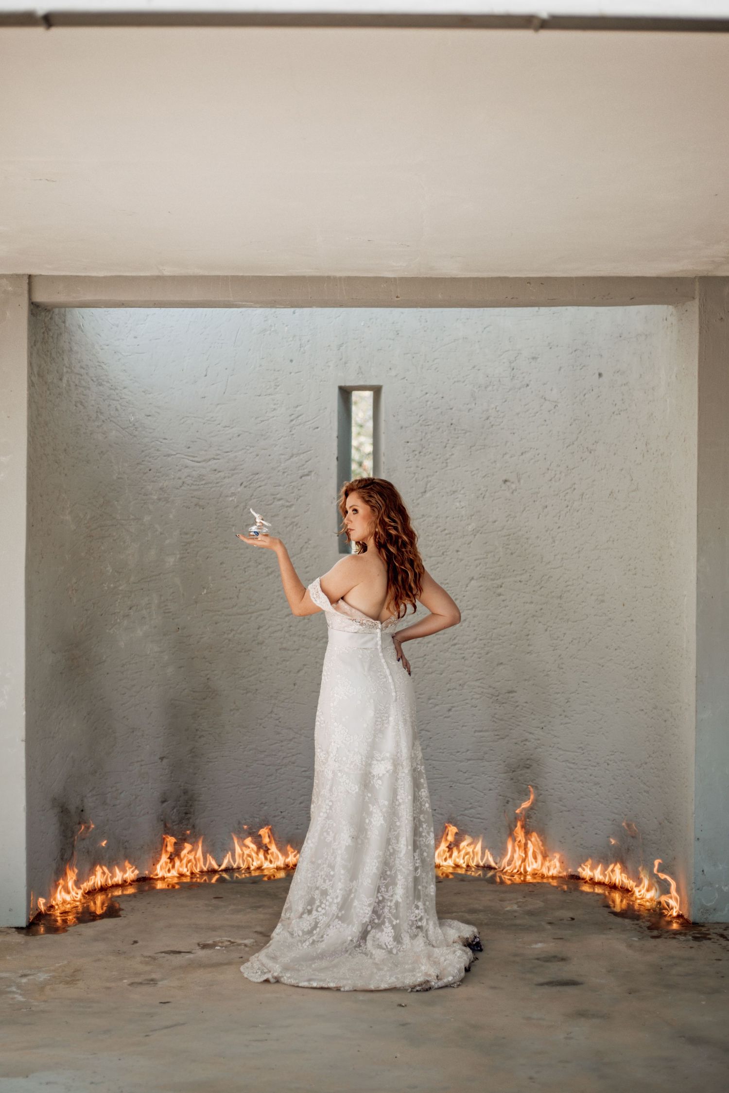 Six sequential shots showing a wedding dress against a wall with a dramatic line of flames spreading behind it.
