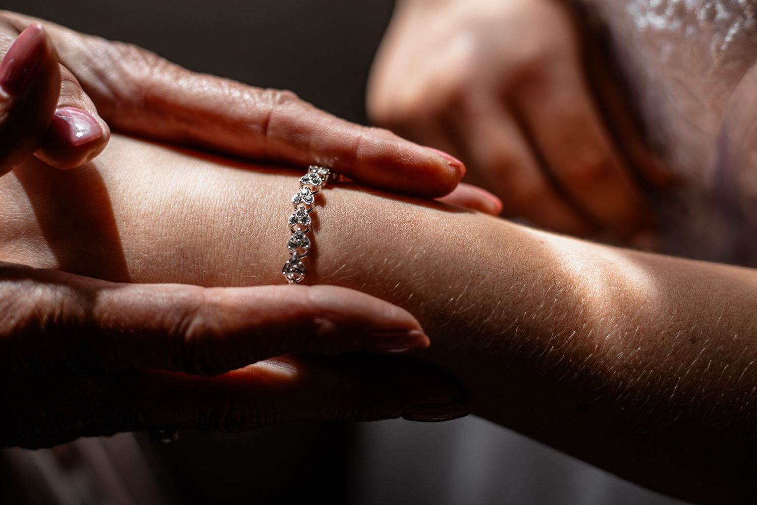 Several hands engaged in a handhold sequence on a dark background showing artistic intertwined movements and gestures.