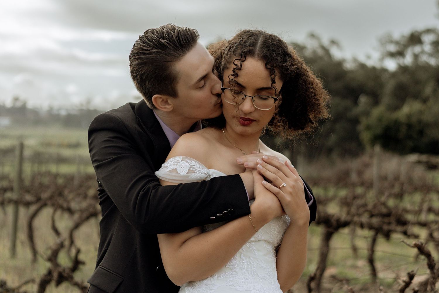 A romantic outdoor wedding photo montage showing couples embracing and kissing in various rustic vineyard settings.