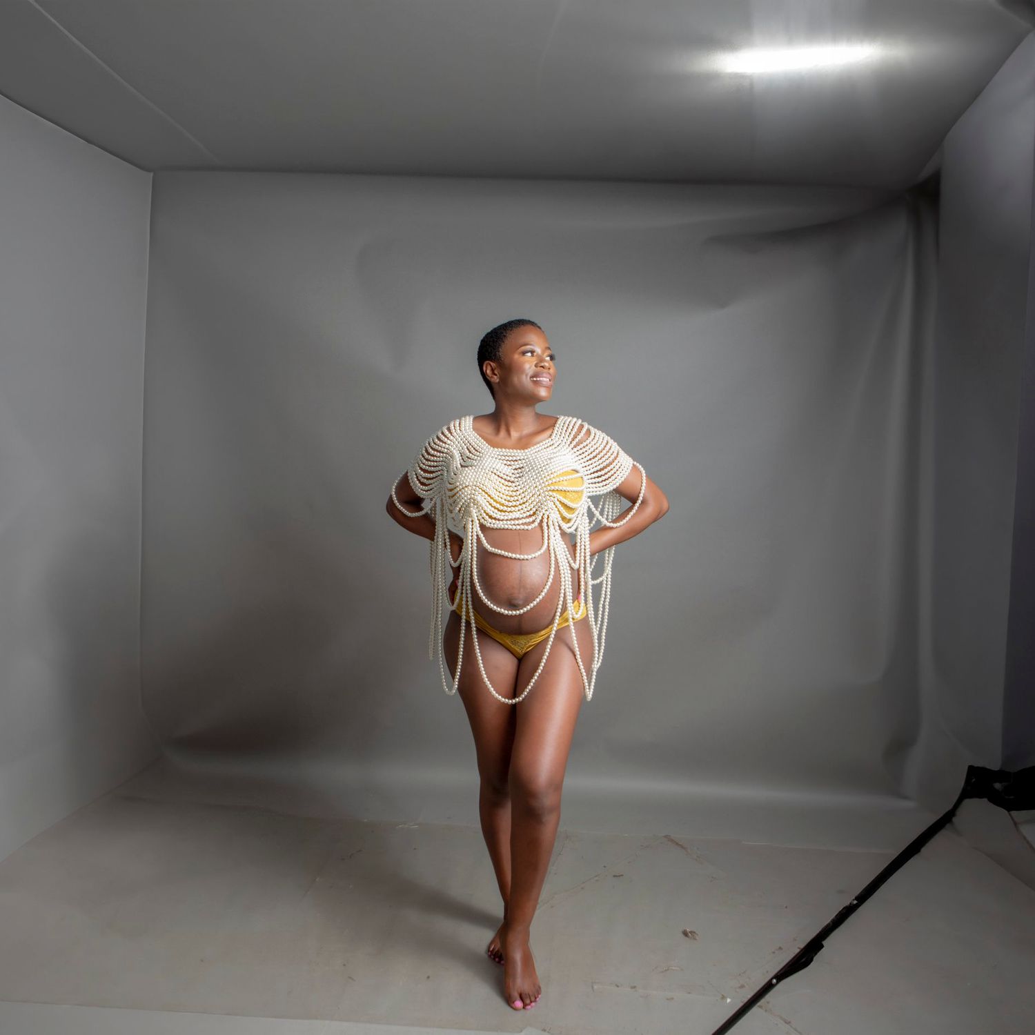 Series of graceful dance poses photographed in a minimalist white studio setting.